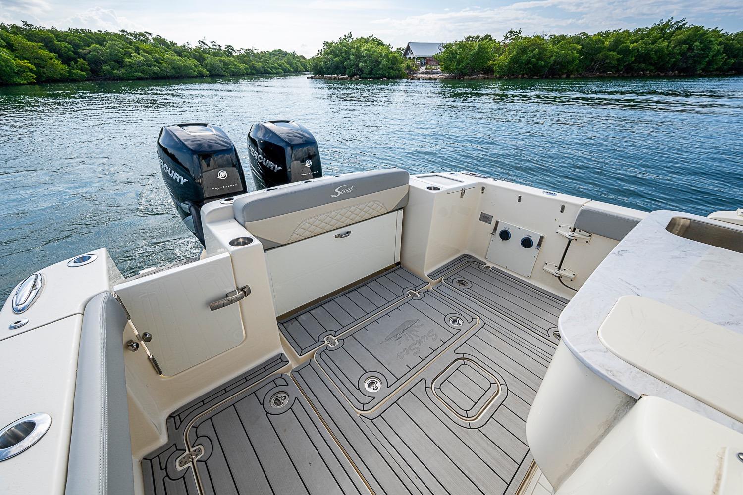 2021 Scout 330 LXF boat deck with dual Mercury engines on calm water.