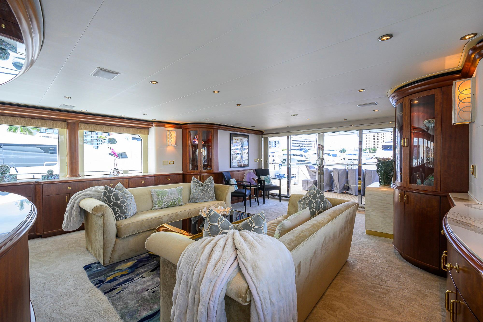 Luxurious interior of 2003 Cheoy Lee Trideck yacht with elegant furnishings and large windows.
