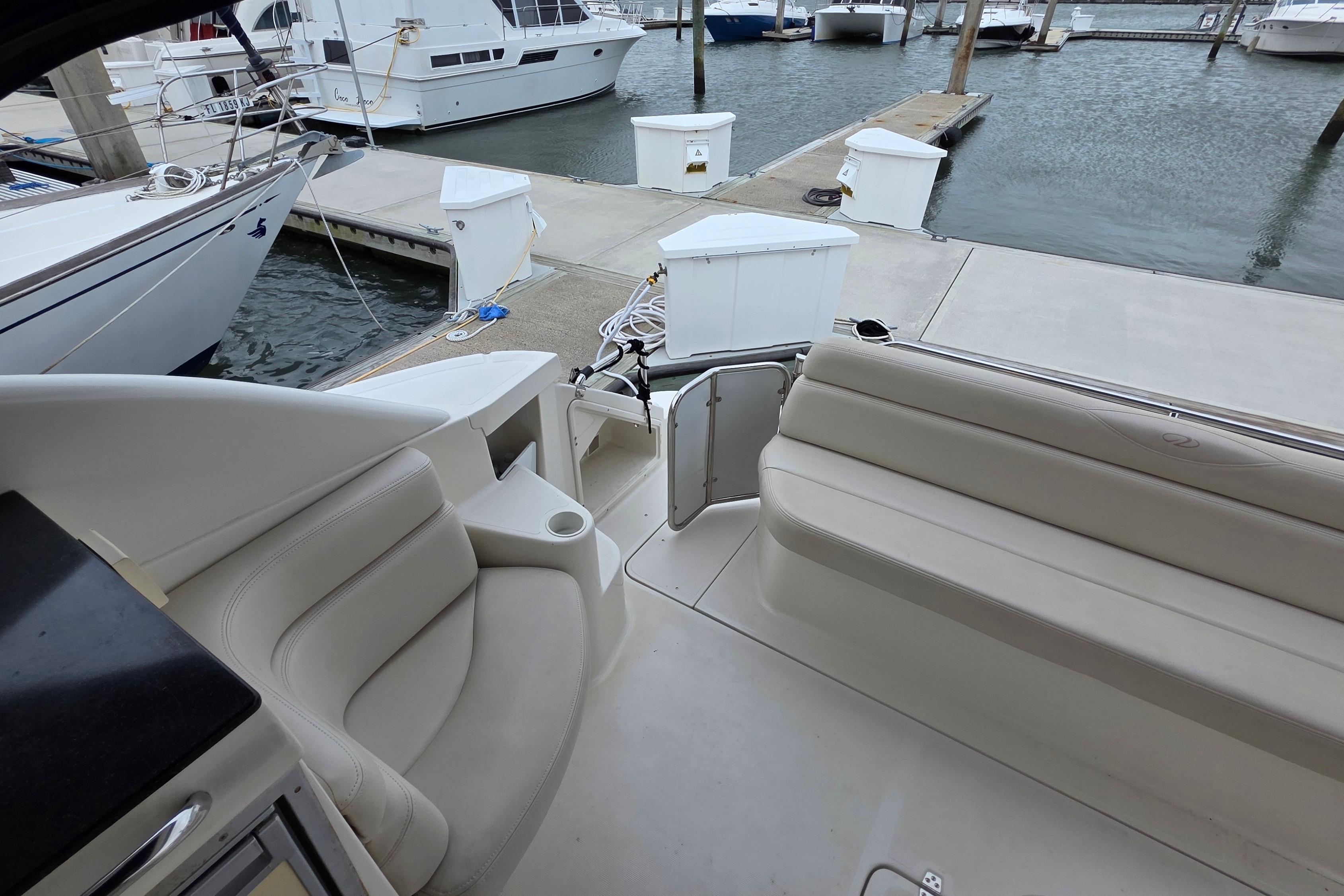 2002 Regal Commodore 4260 yacht interior with seating, docked at marina.