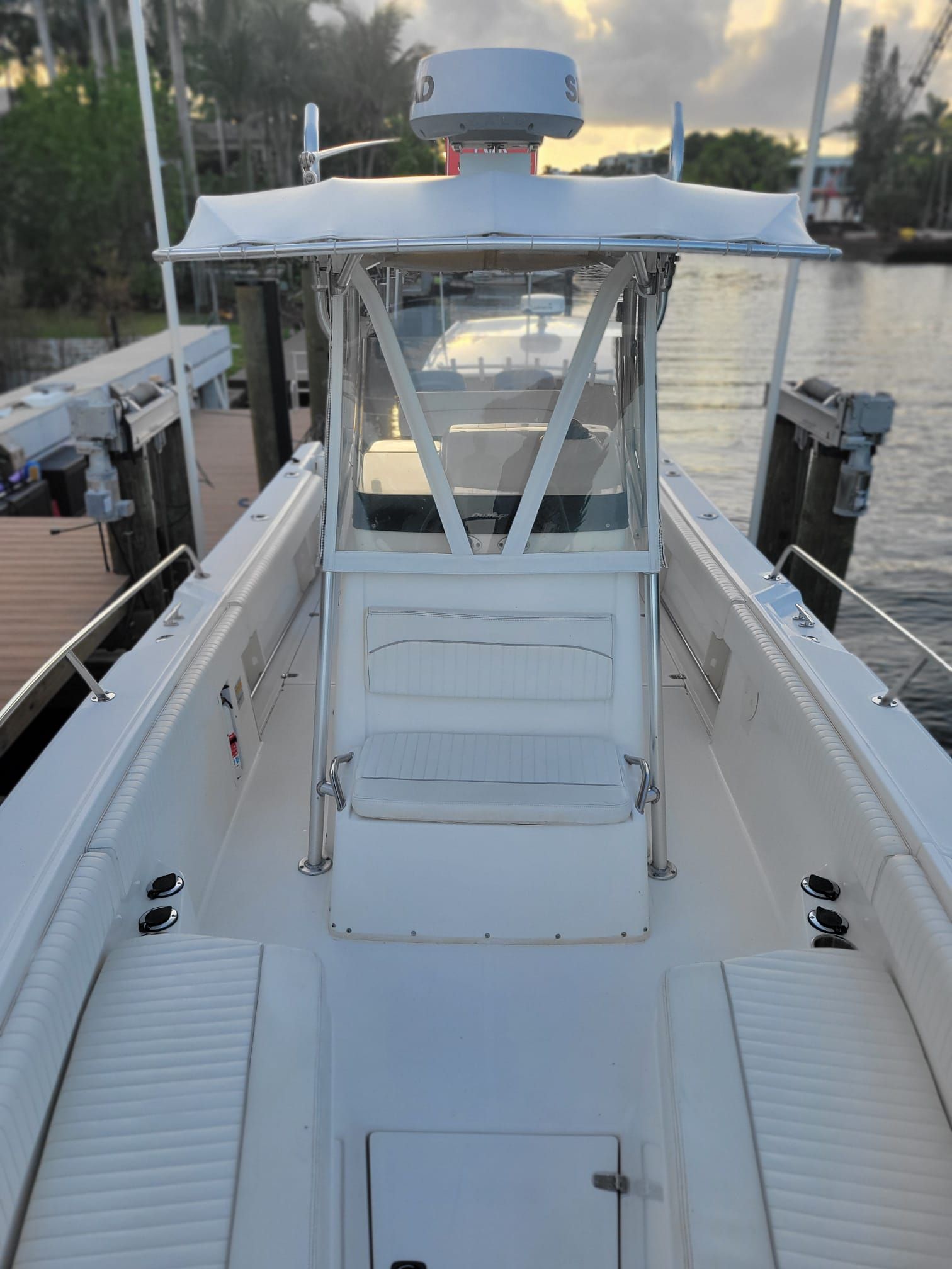 Boston Whaler 26 Outrage 2001 on calm water at dock.
