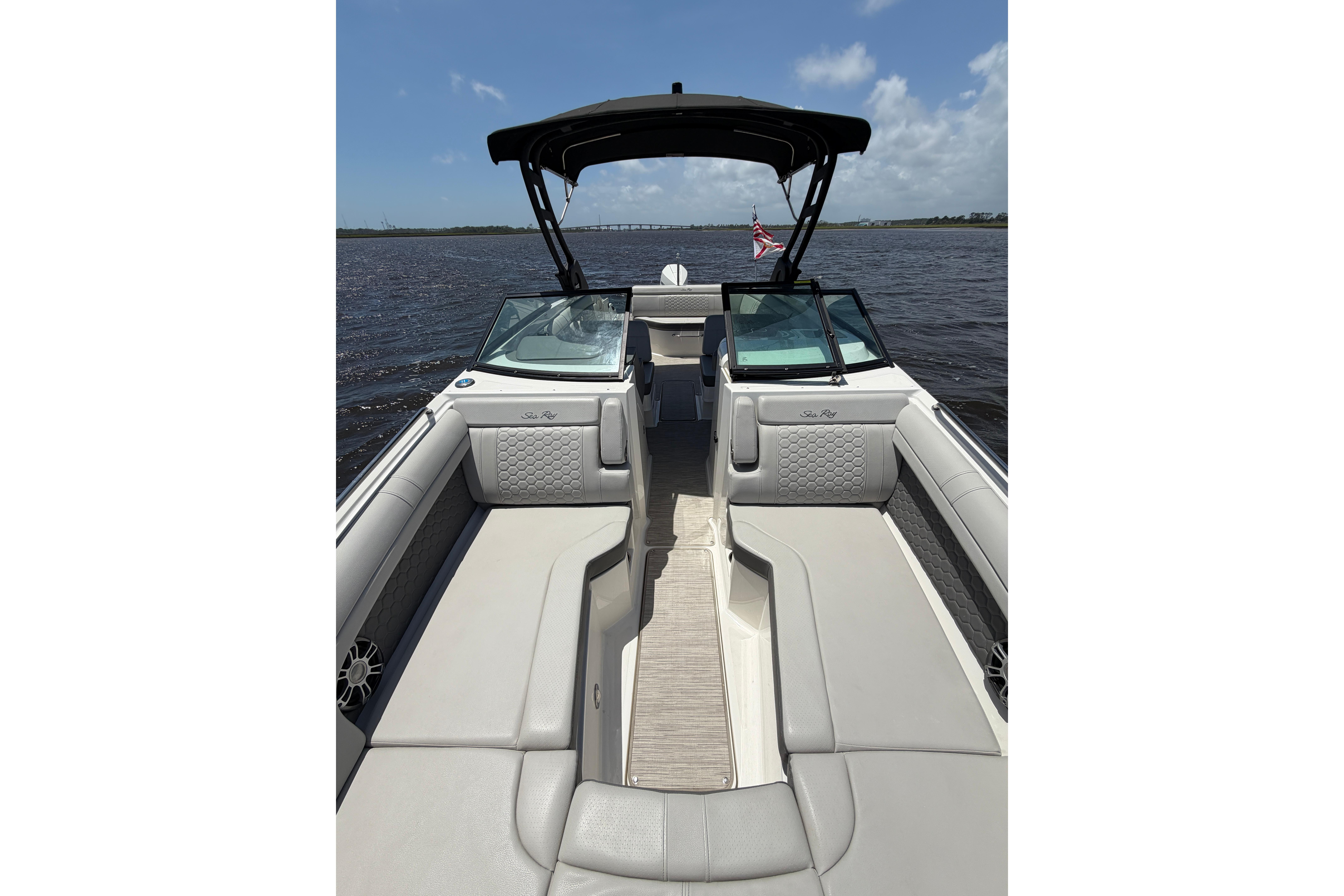 2024 Sea Ray SDX 270 Outboard boat interior with luxurious seating on a sunny day.