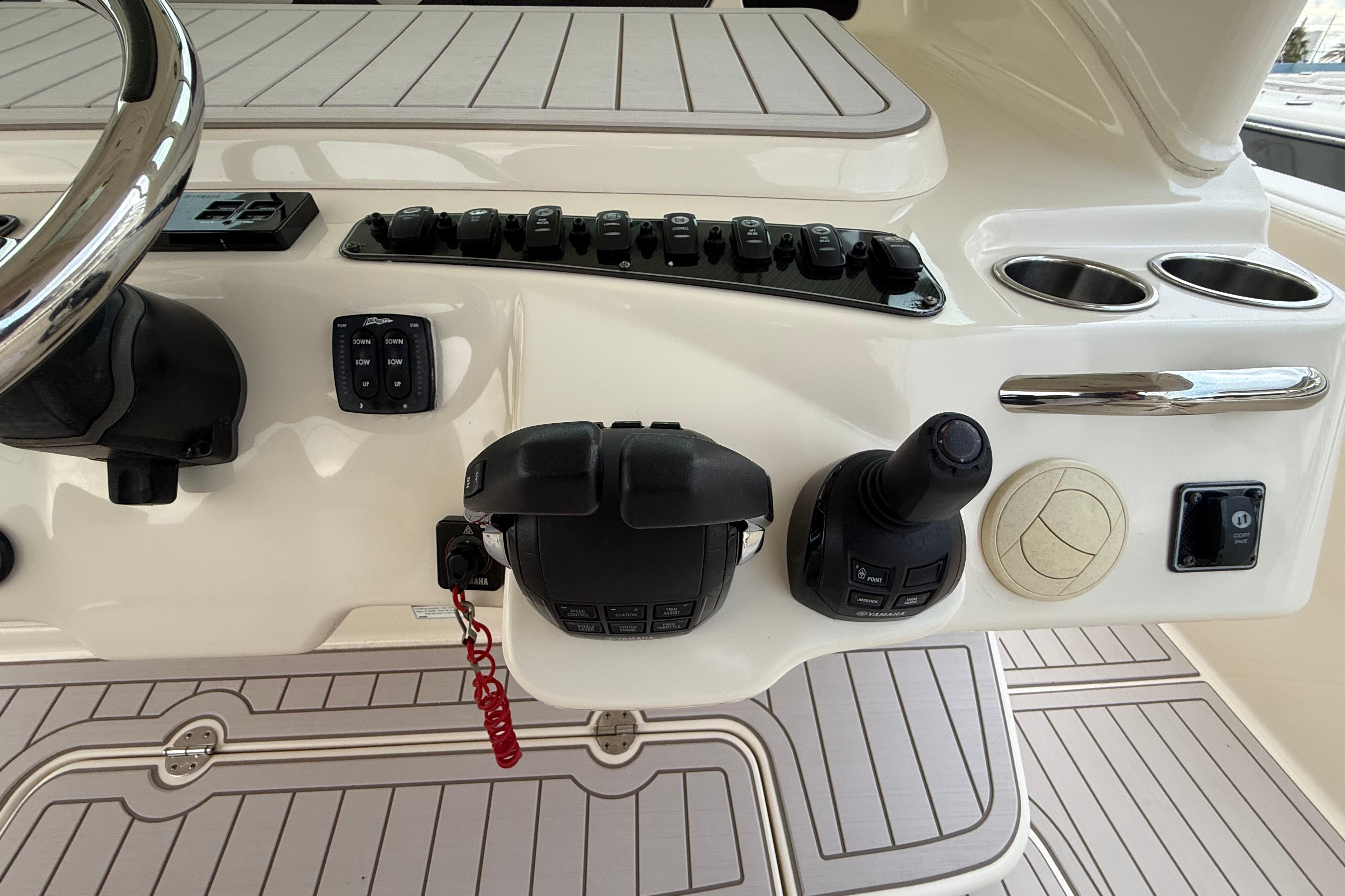 Control panel of 2020 Grady-White Canyon 336 boat with steering wheel and switches.