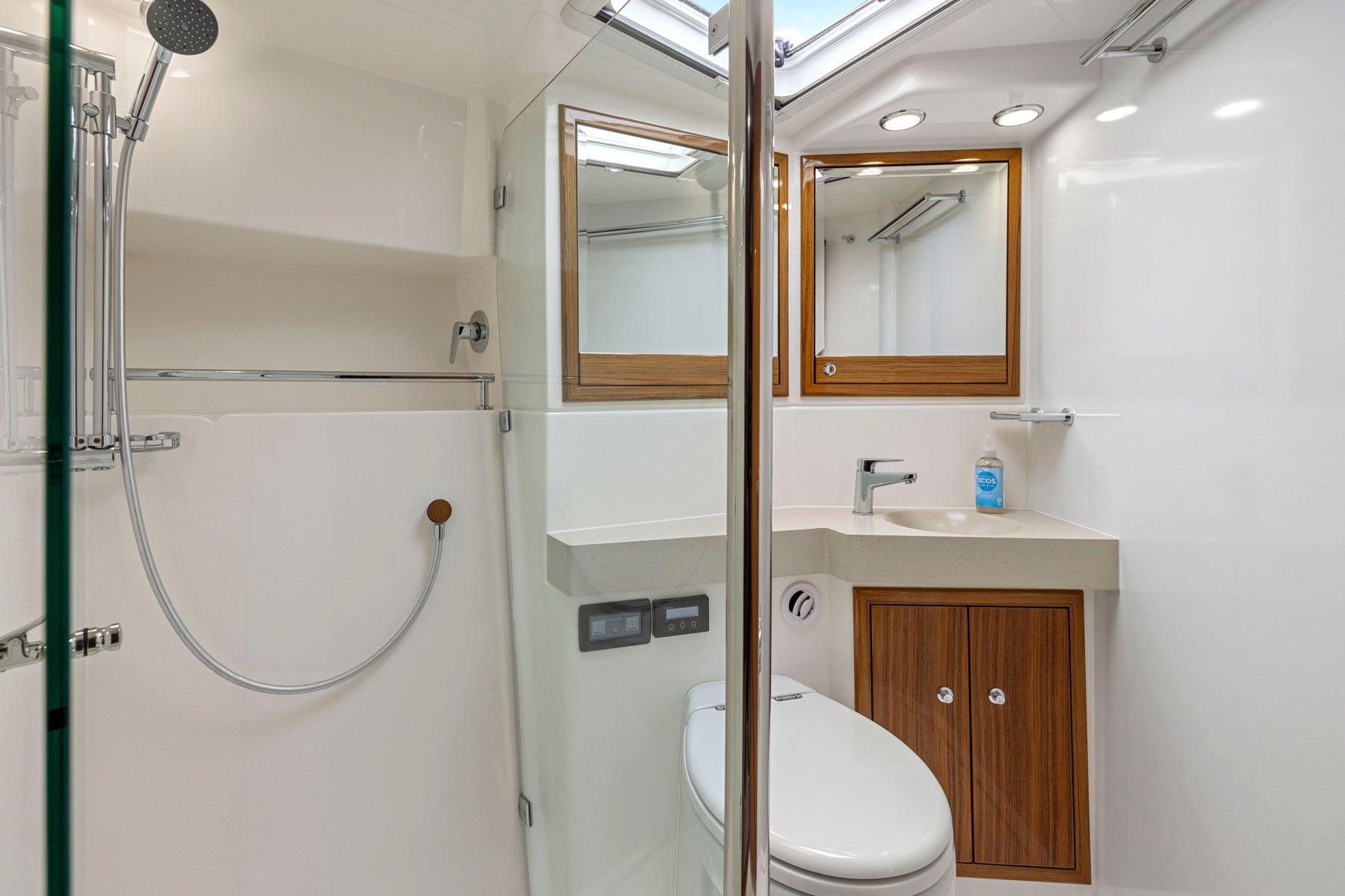Luxurious 2014 Maritimo M50 yacht bathroom with modern fixtures and wooden accents.