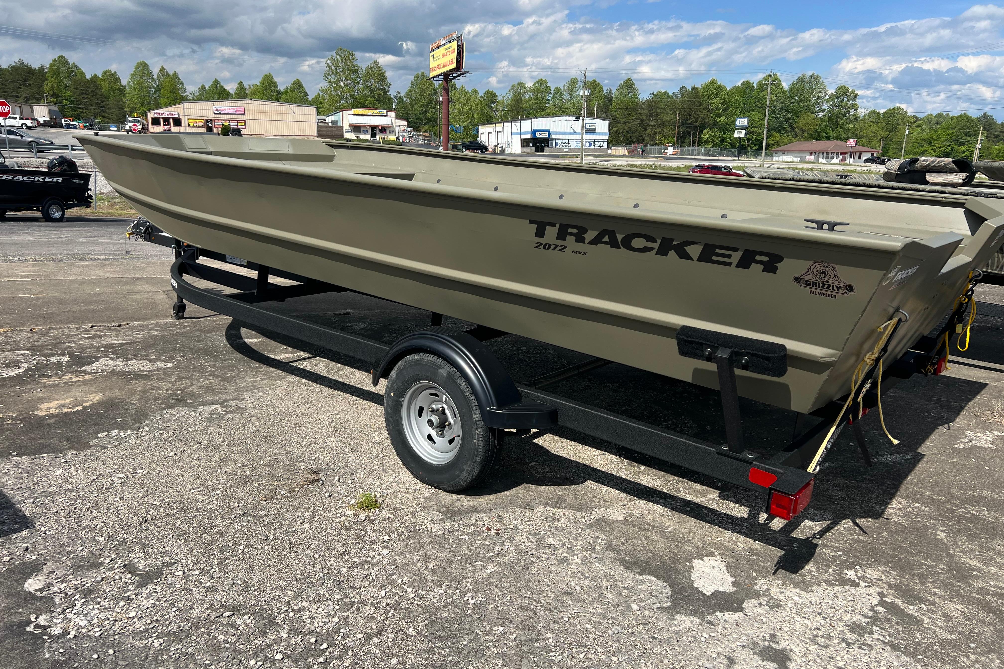 2025 Tracker Grizzly 2072 Utility boat on trailer in outdoor setting.