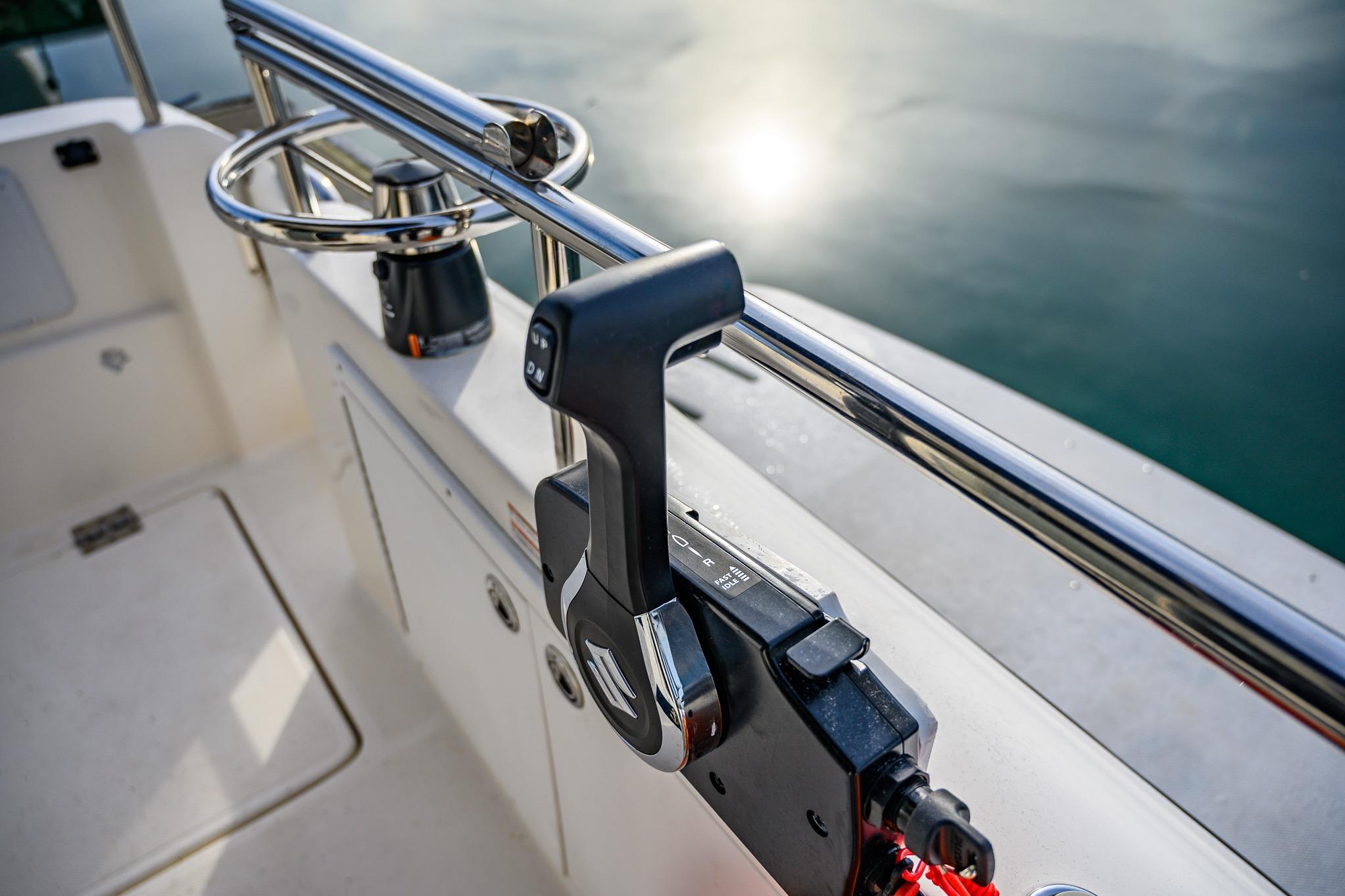 Control lever on 2012 Aspen C90 boat, with water reflection in the background.