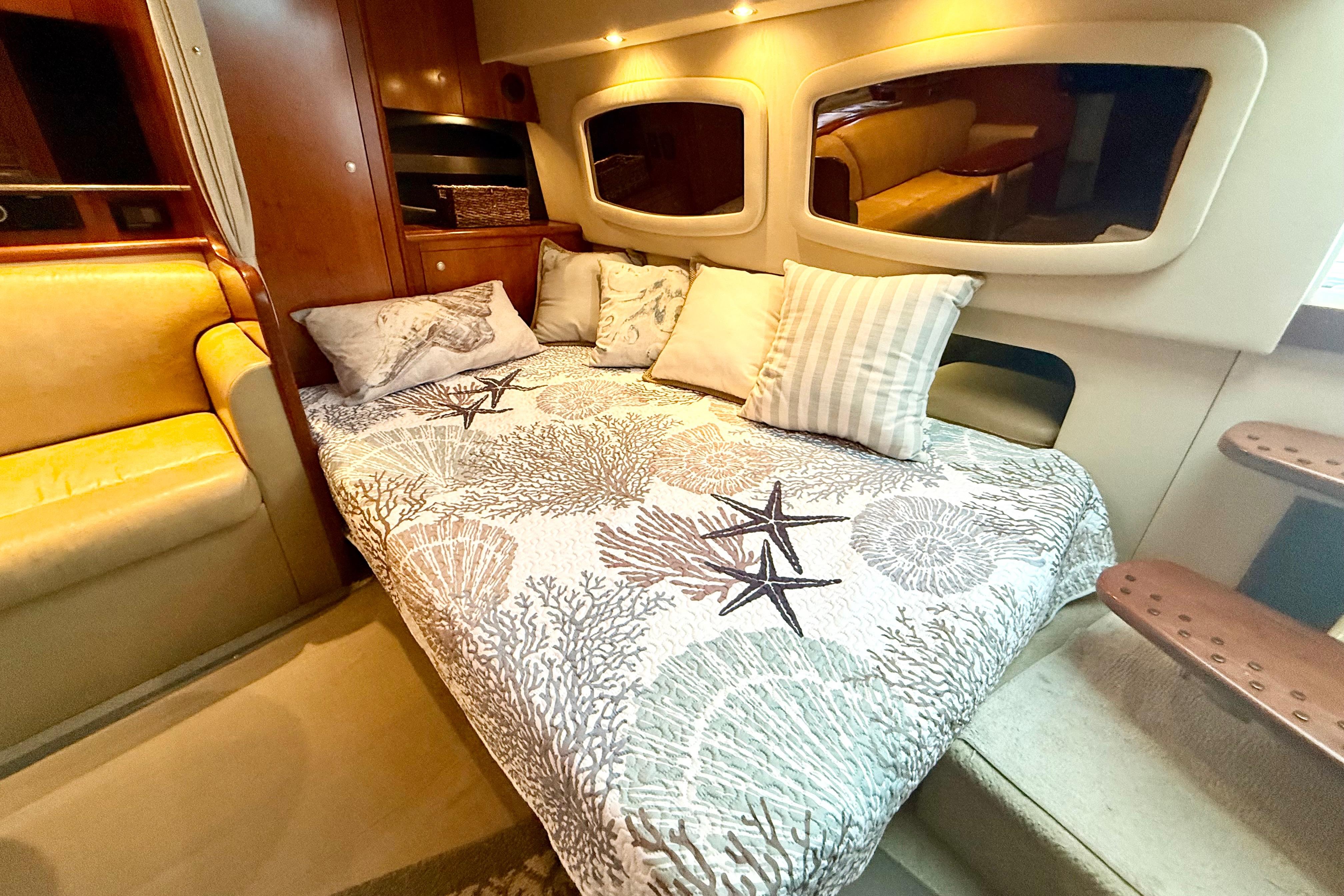 Luxurious interior of 2011 Cruisers Yachts 390 Sports Coupe with cozy bedding and elegant decor.