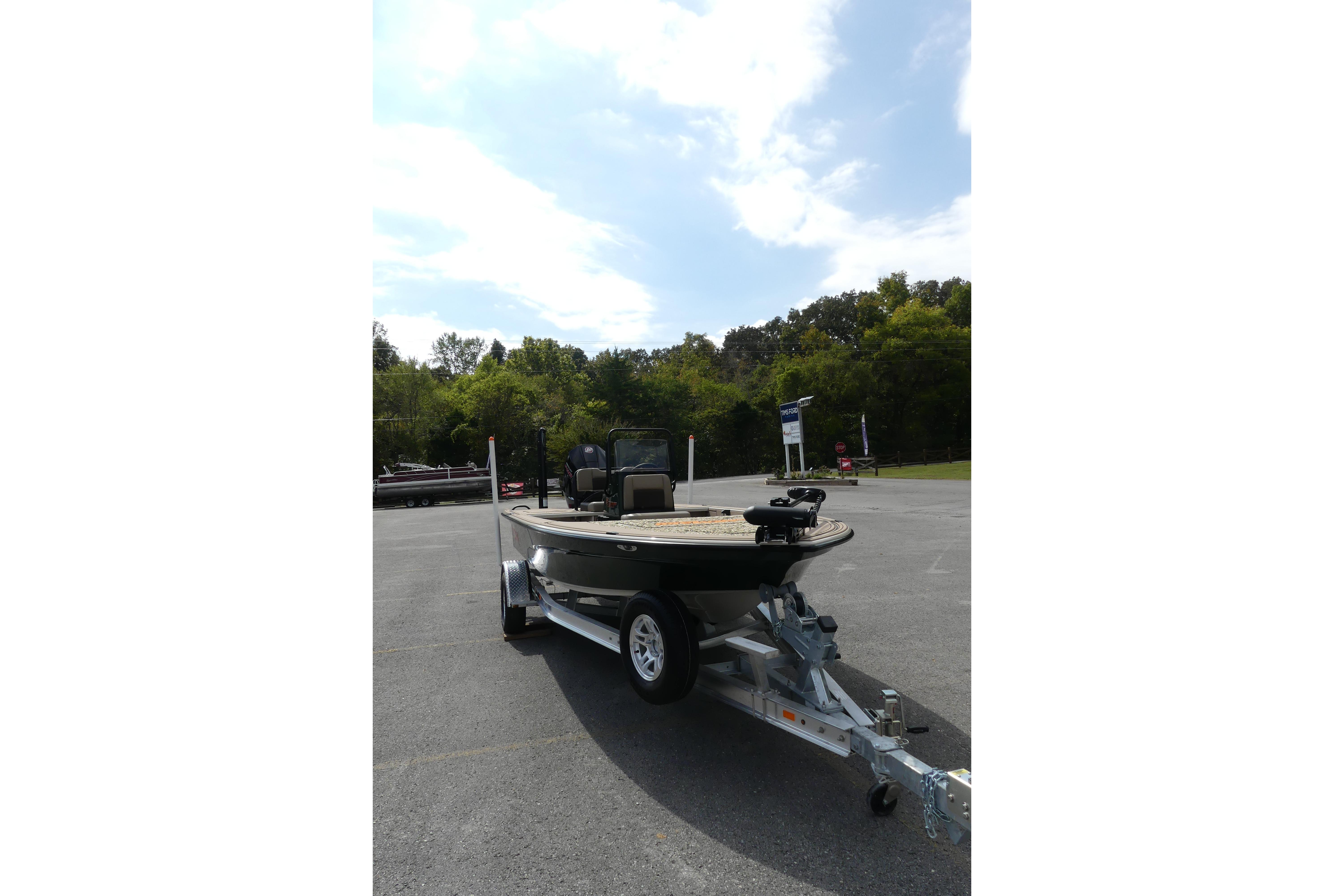 2025 Mako 18 Pro Skiff Backwater Edition on trailer in parking lot.