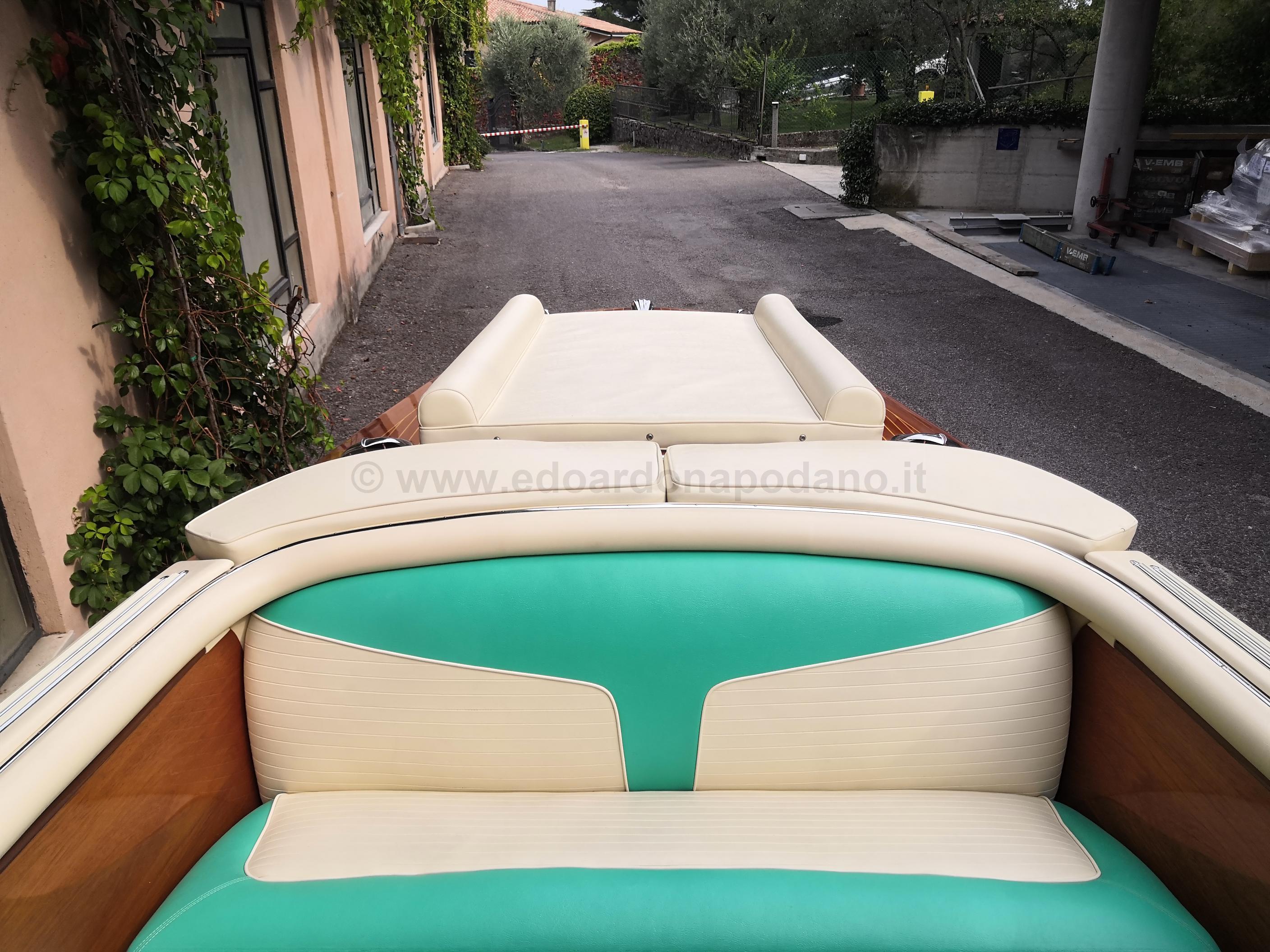 1963 Riva Ariston boat interior with vintage teal and cream upholstery.