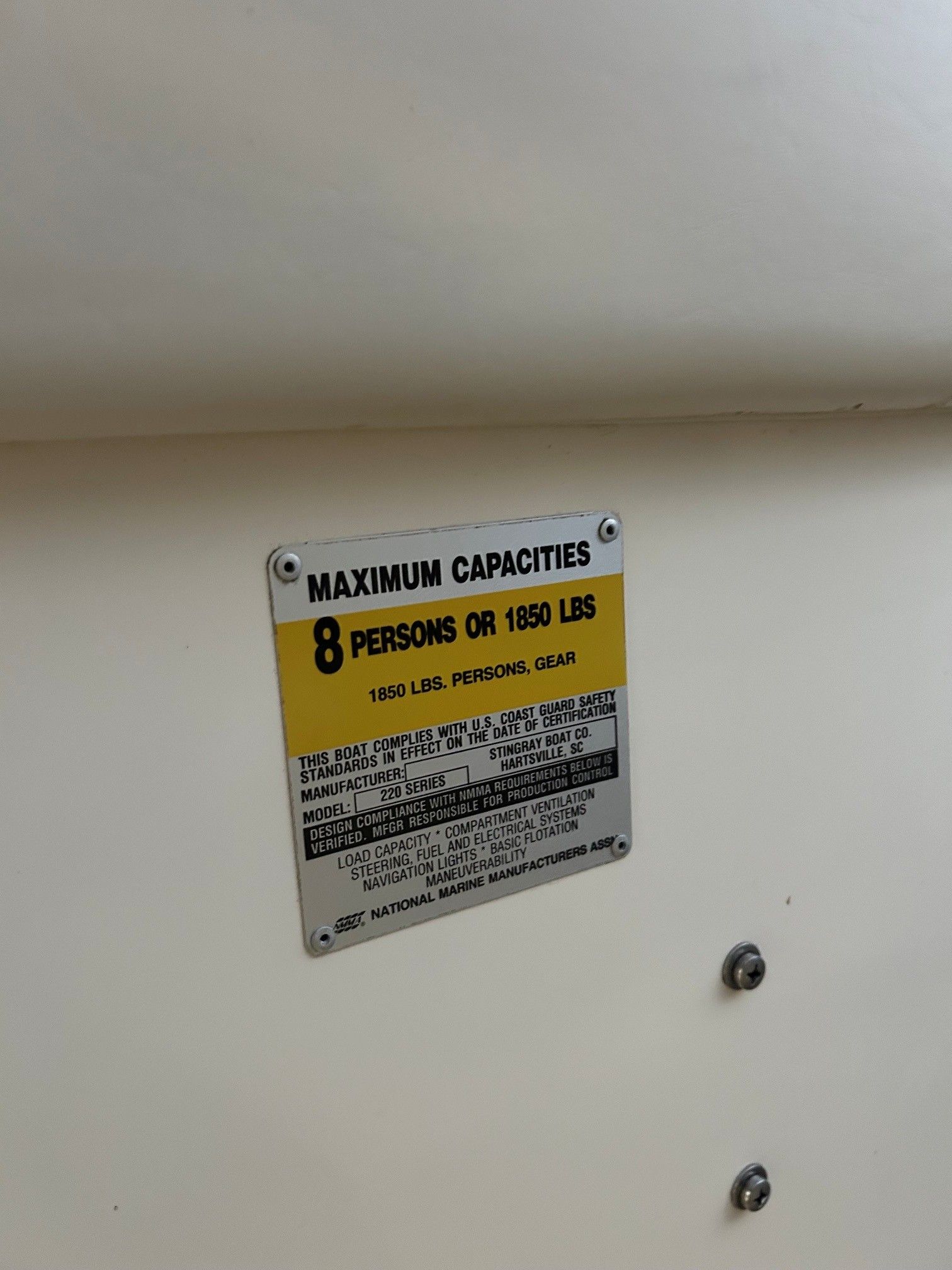 A sign displays the maximum capacity of 8 persons or 1850 pounds on board.