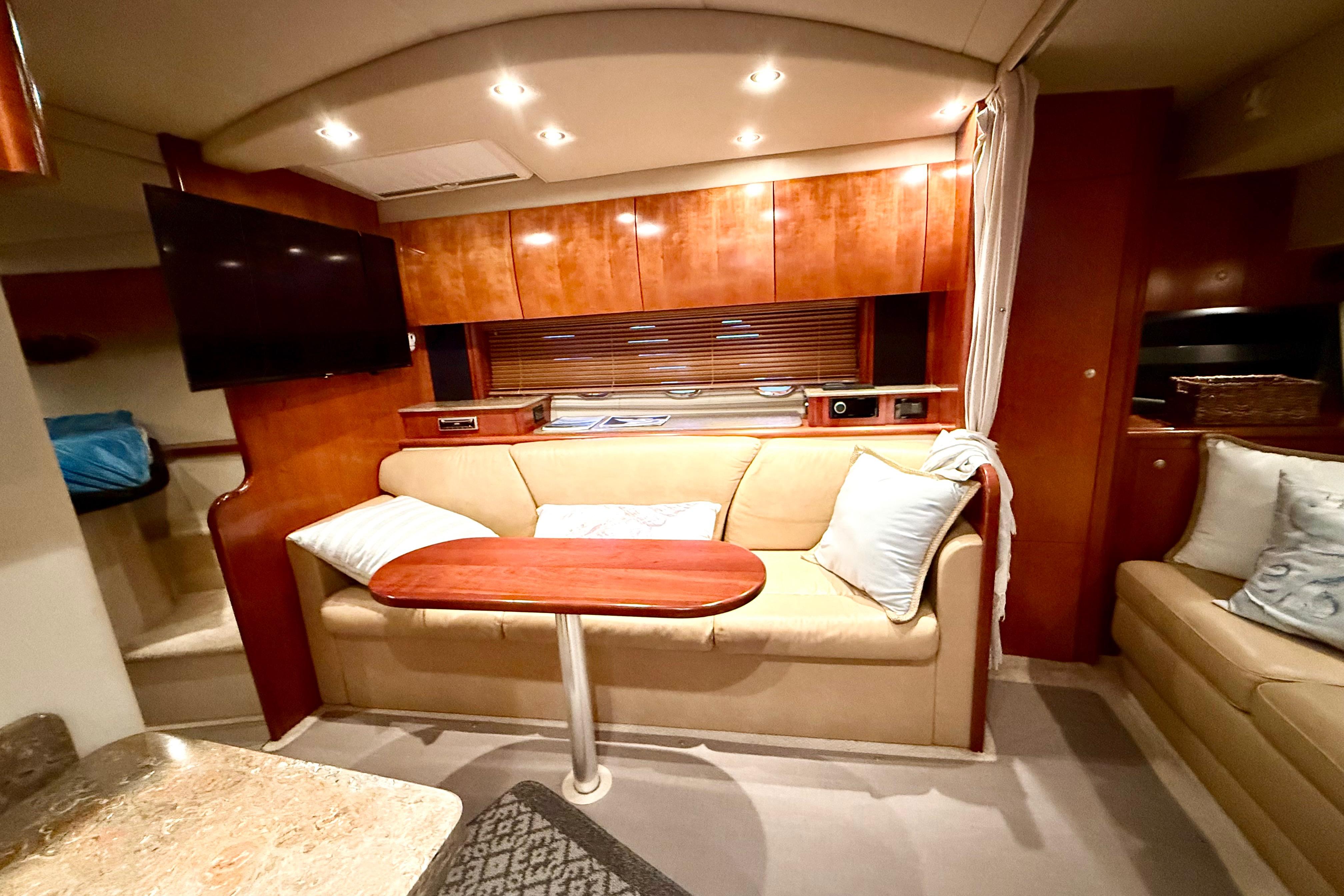Luxurious interior of 2011 Cruisers Yachts 390 Sports Coupe with cozy seating and elegant wood finishes.