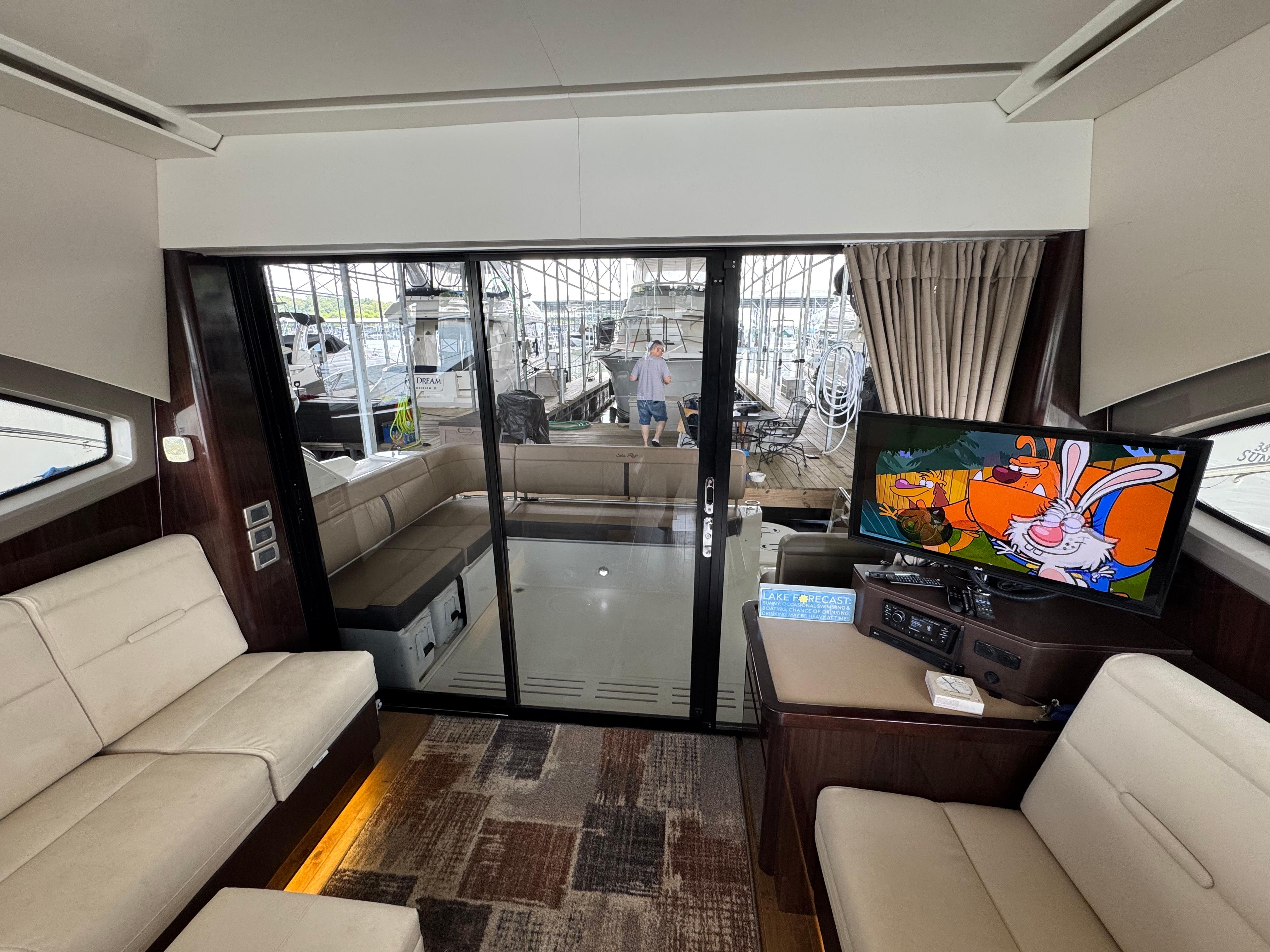 Luxurious interior of 2017 Sea Ray Sundancer 400 yacht with TV and seating area.