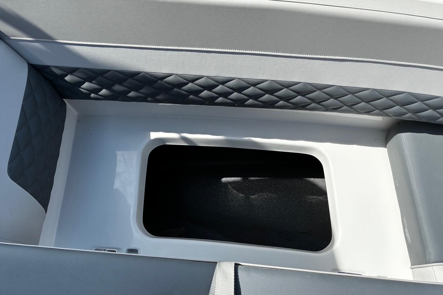 Interior storage compartment of 2026 Starcraft SVX 191 OB boat with quilted upholstery.