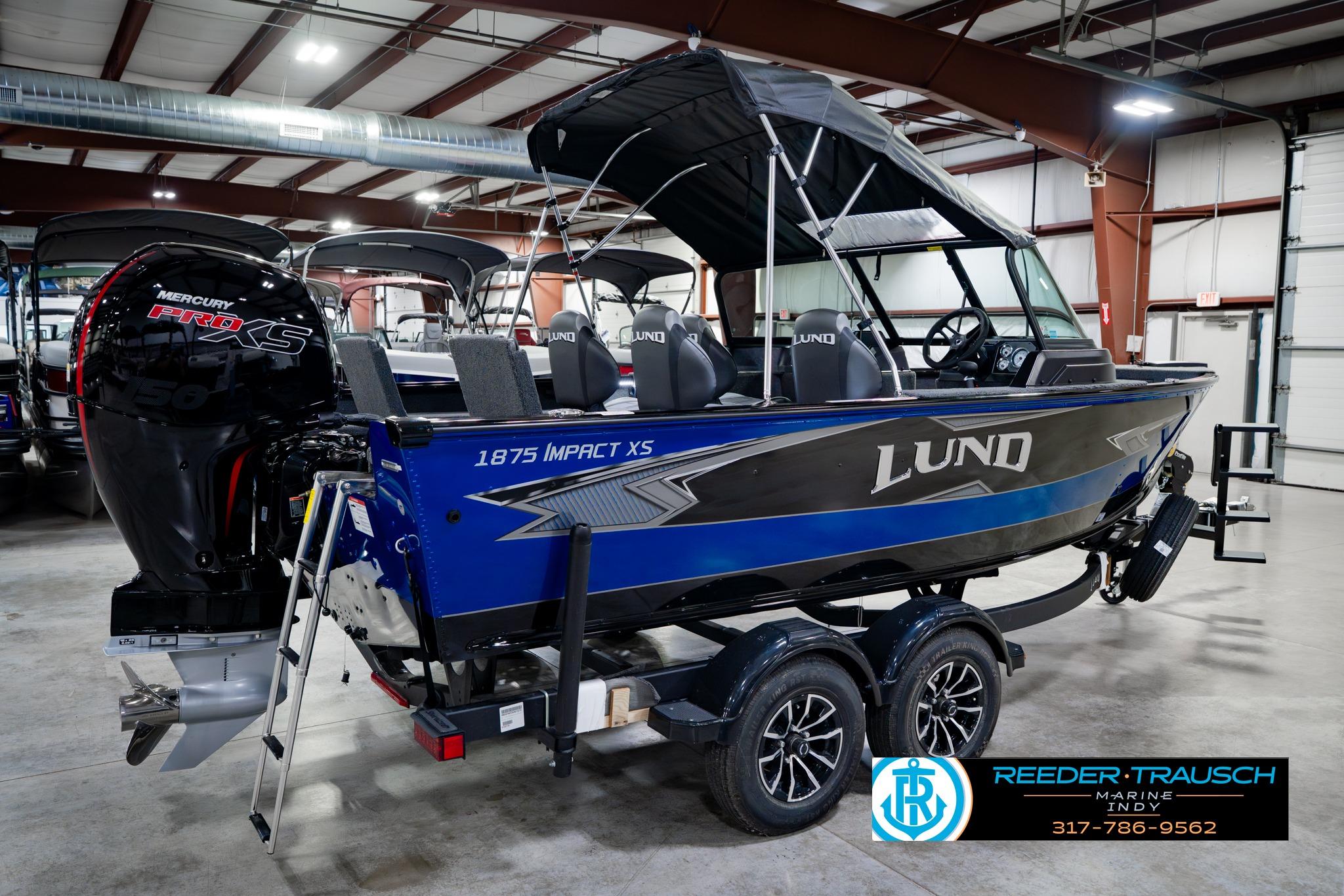 2026 Lund 1875 Impact XS boat with Mercury Pro XS engine in showroom.