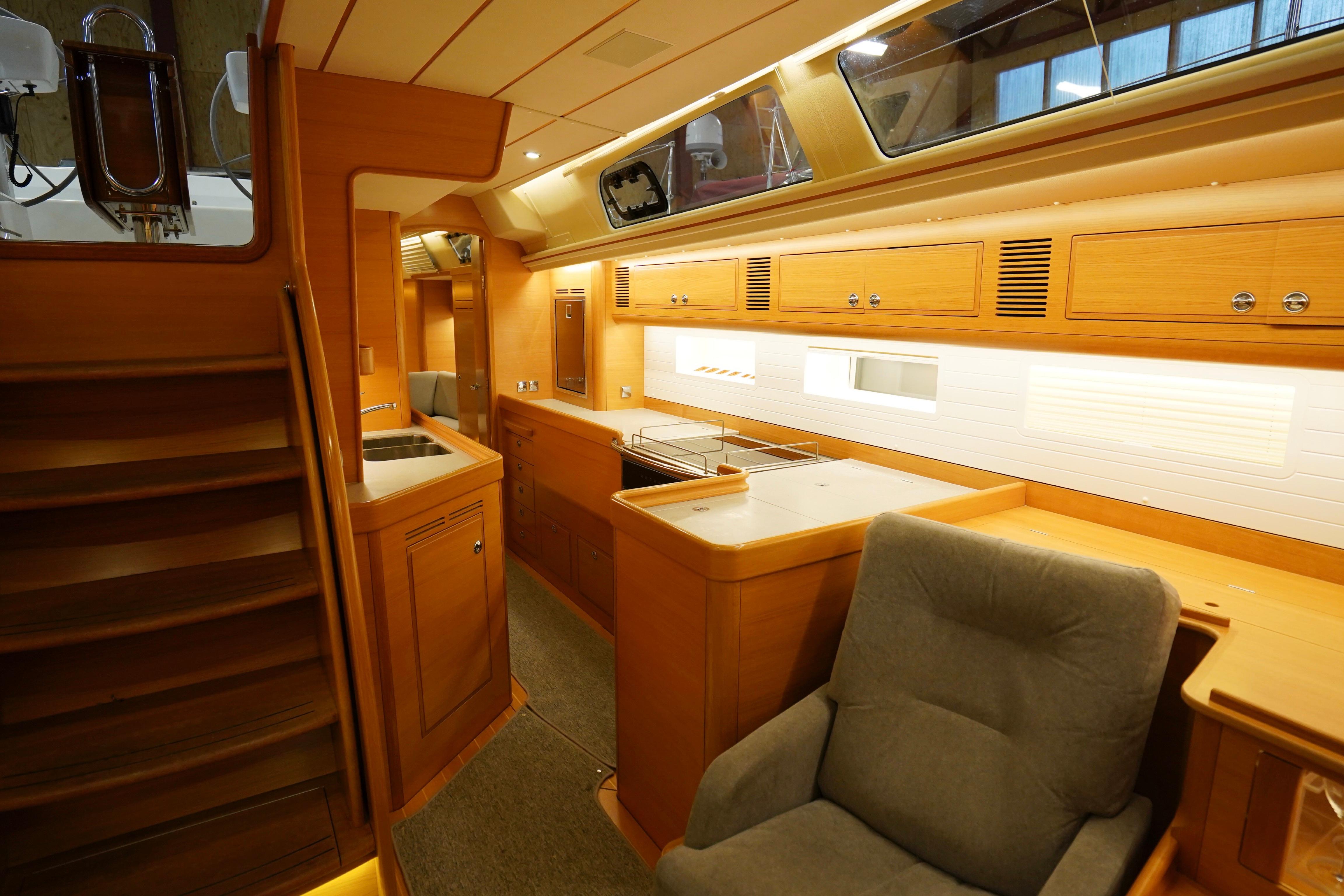 Interior of 2020 Hallberg-Rassy 57 yacht with luxurious wood design.