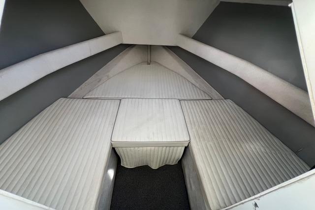 Interior cabin of a 2015 Stanley 30 Custom boat with cushioned seating.