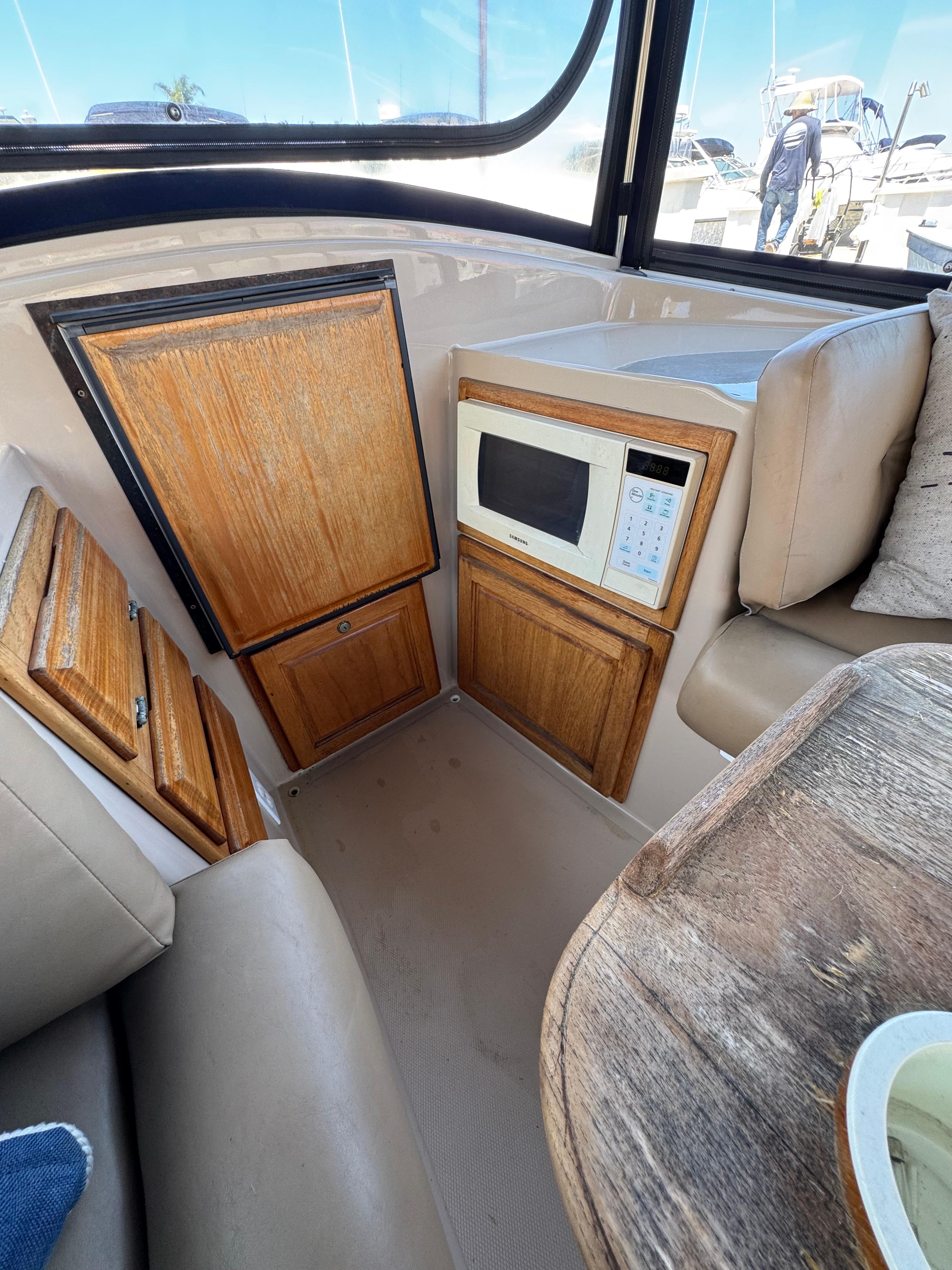 2004 Duffy NEWPORTER interior with microwave, wooden cabinets, and seating area.
