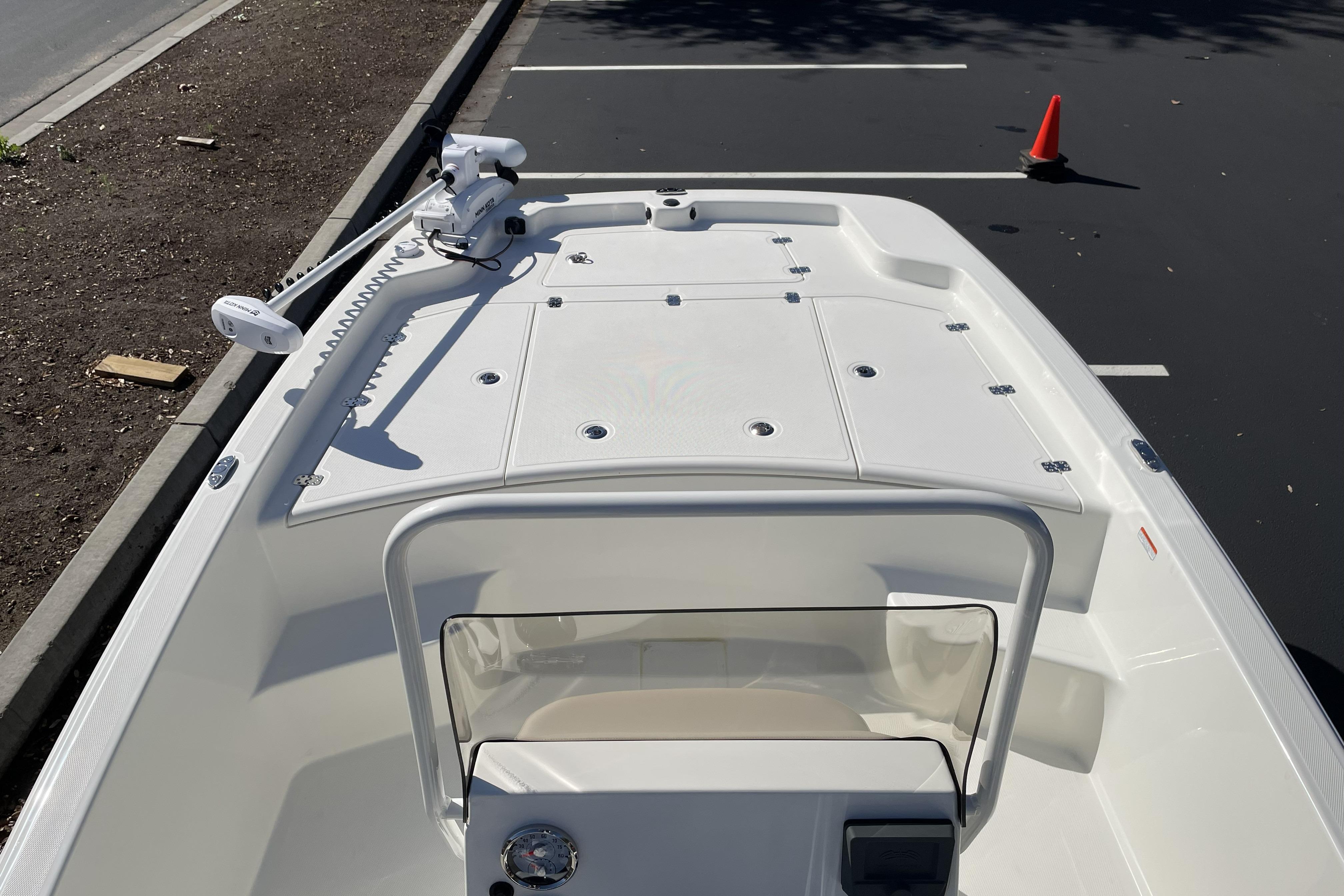 2026 Mako Pro Skiff 19 CC boat with trolling motor in parking lot.
