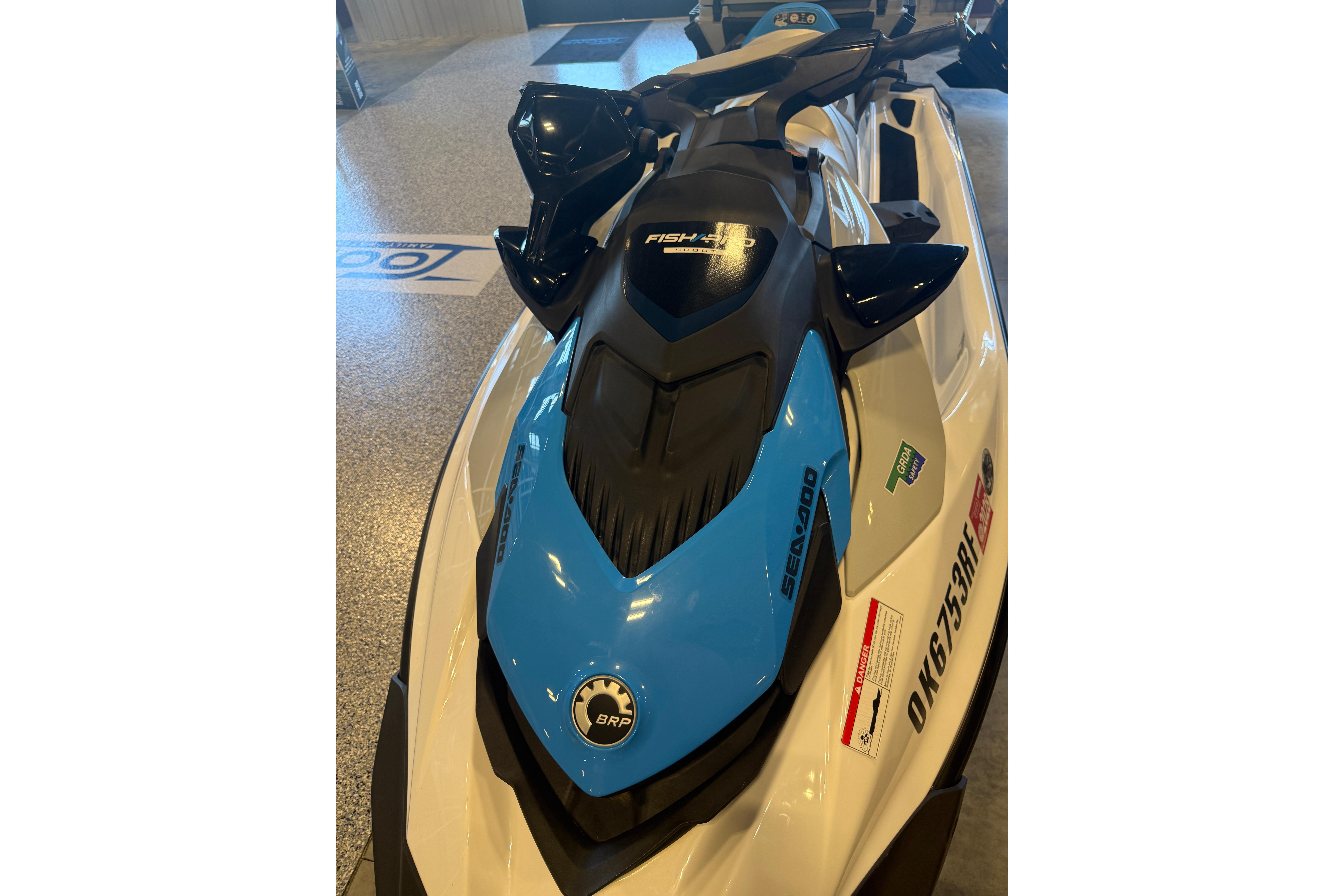 2022 Seadoo FishPro jet ski in showroom, featuring sleek design and blue accents.