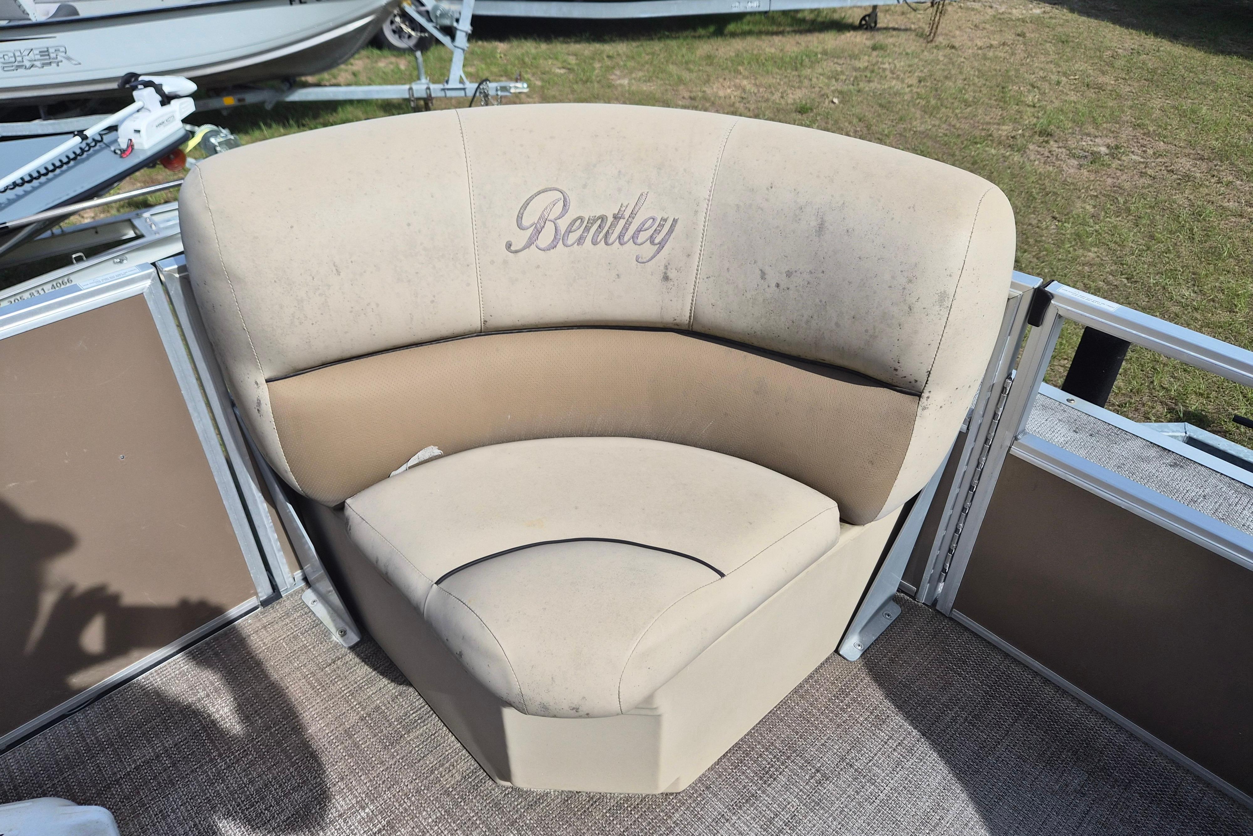 Bentley Pontoons 180 CRUISE 2004 boat seat with beige upholstery and logo.