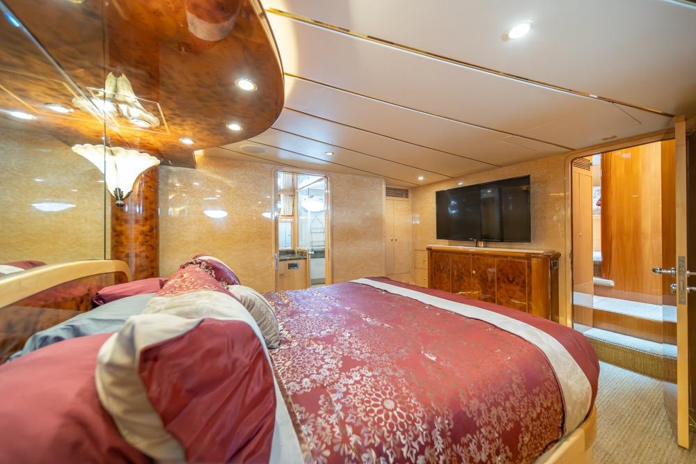 Luxurious bedroom interior of 2005 Ocean Alexander 64 Motoryacht with elegant wood finishes.
