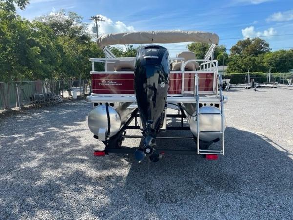 2024 Sun Tracker Bass Buggy 18 DLX pontoon boat, rear view with outboard motor.