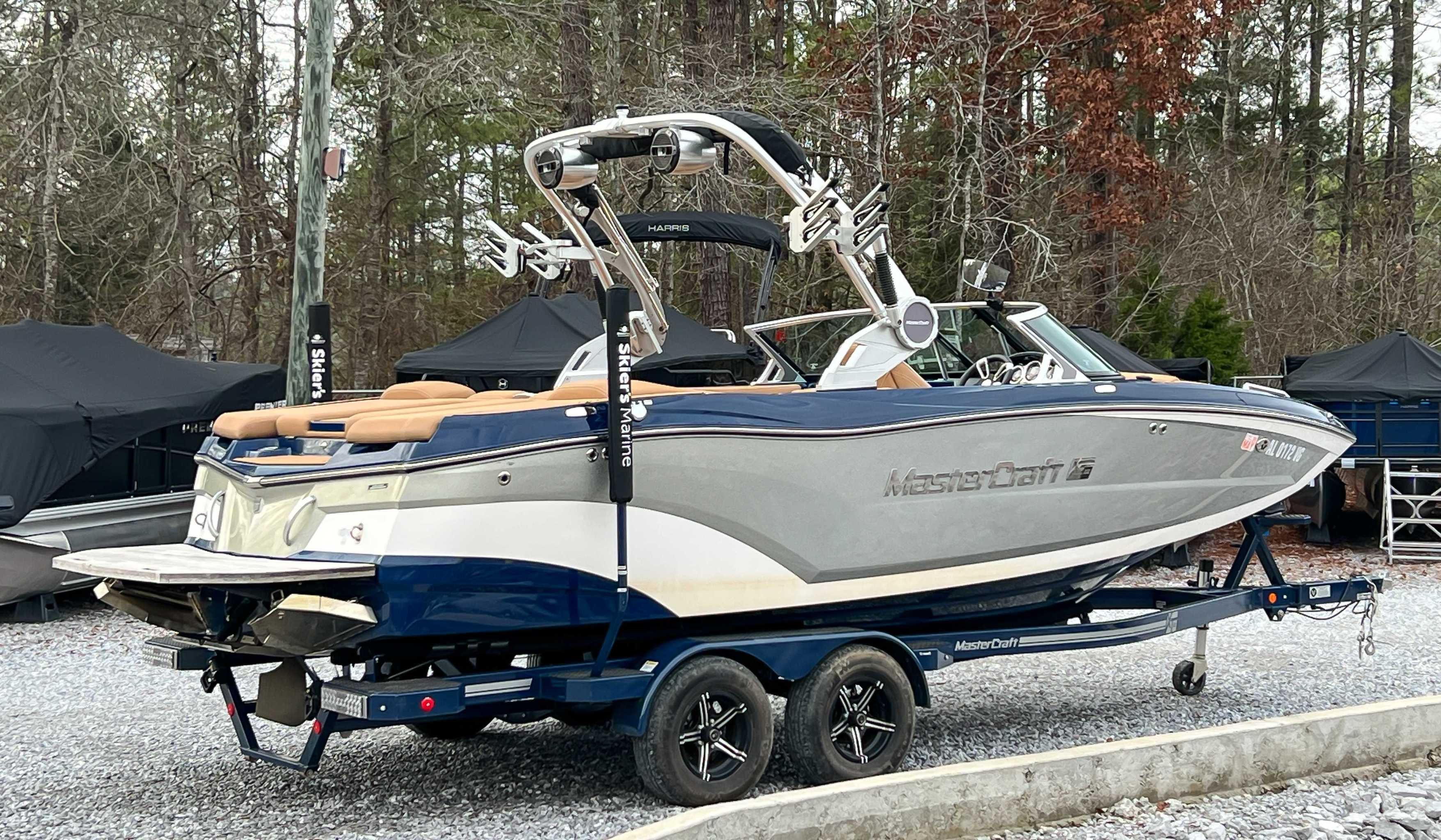 2021 MasterCraft XT22 boat parked on trailer outdoors.
