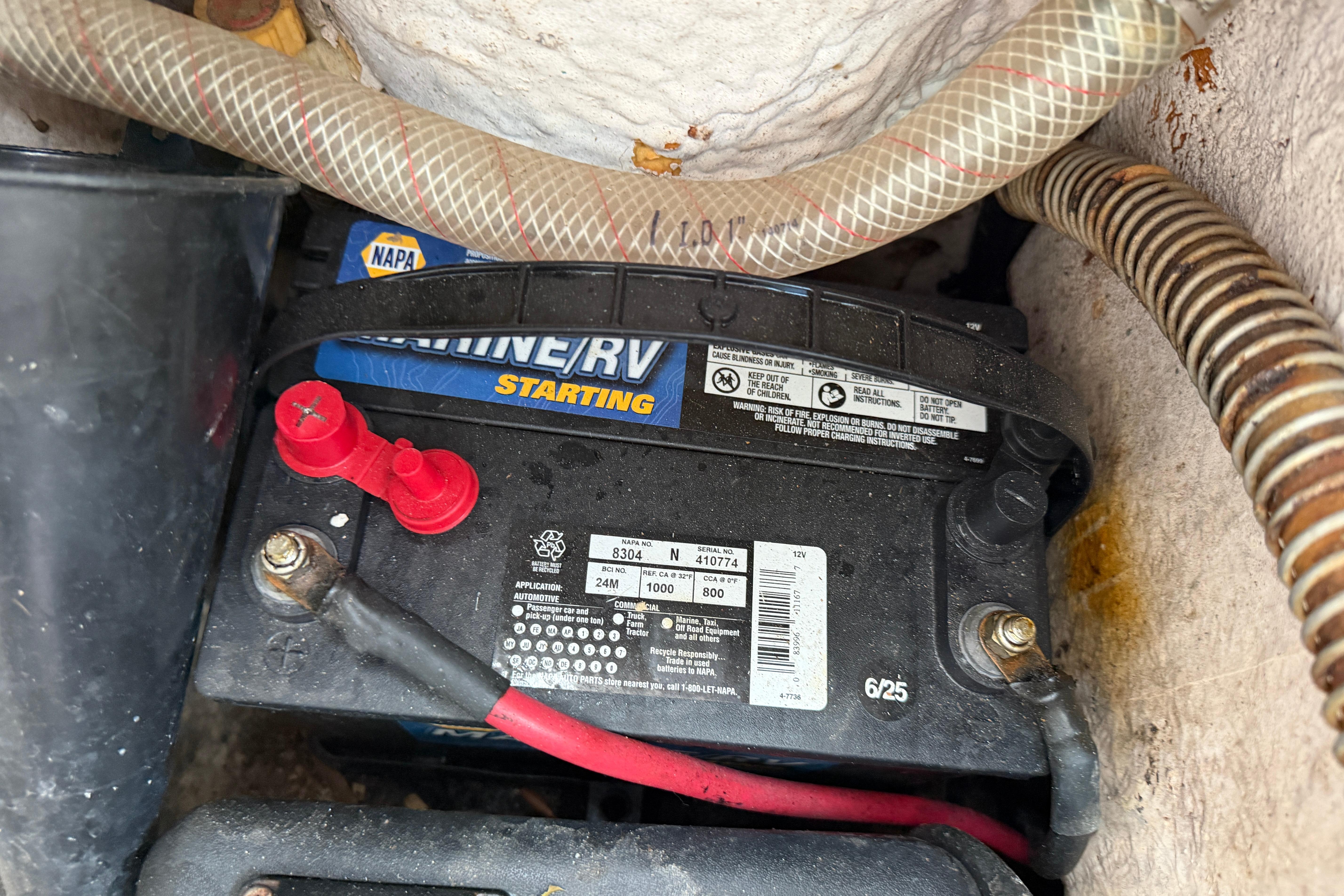 Battery compartment of a 1987 Grady-White Seafarer 226 with NAPA Marine/RV battery.