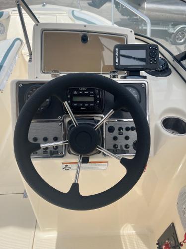 2021 Scout 210 Dorado boat dashboard with steering wheel and navigation system.