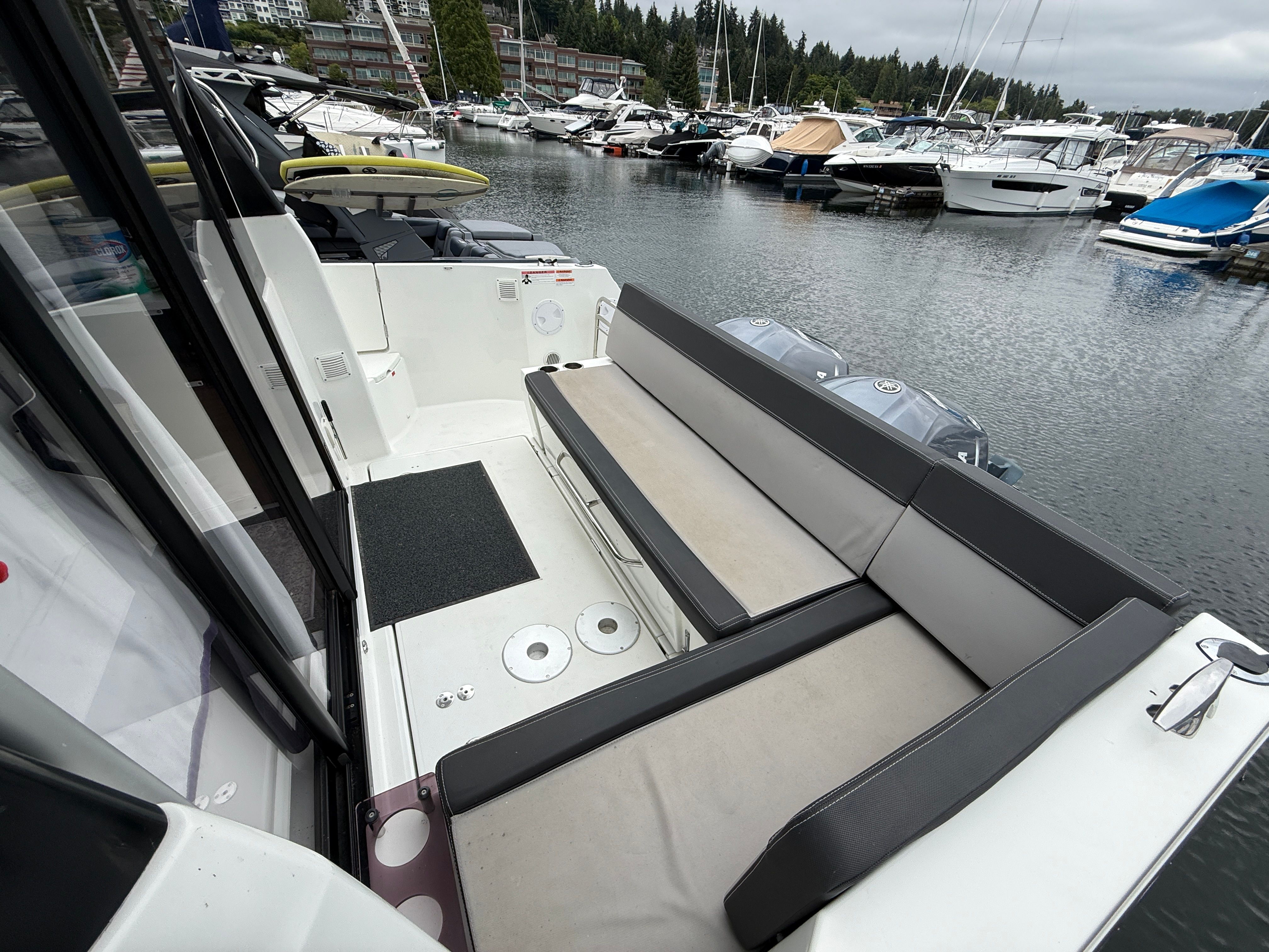The image shows the stern of a 2021 Jeanneau NC 1095 docked in a marina.