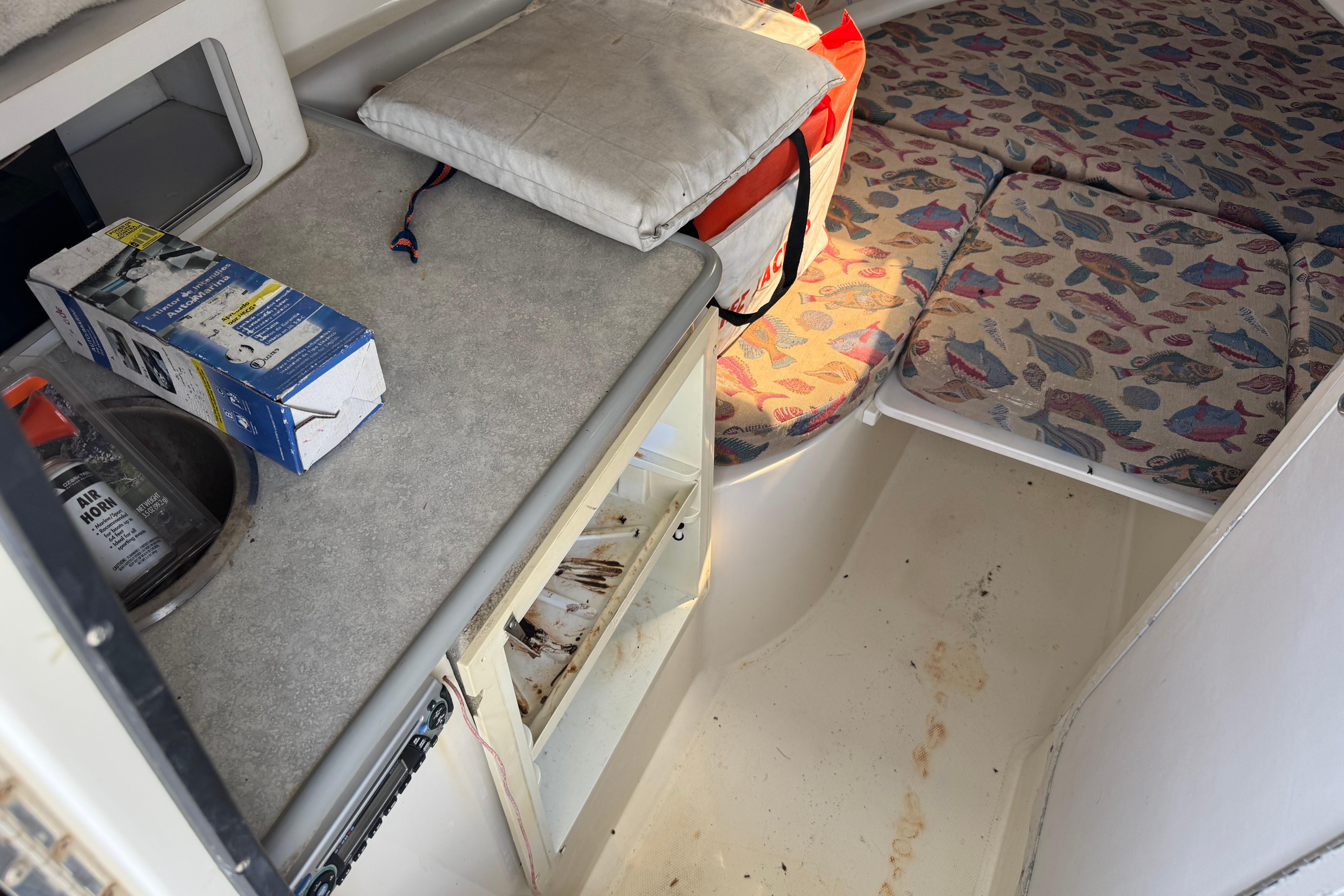 1997 Hydra-Sports VECTOR 2650 WA cabin interior with sink, storage, and patterned cushions.