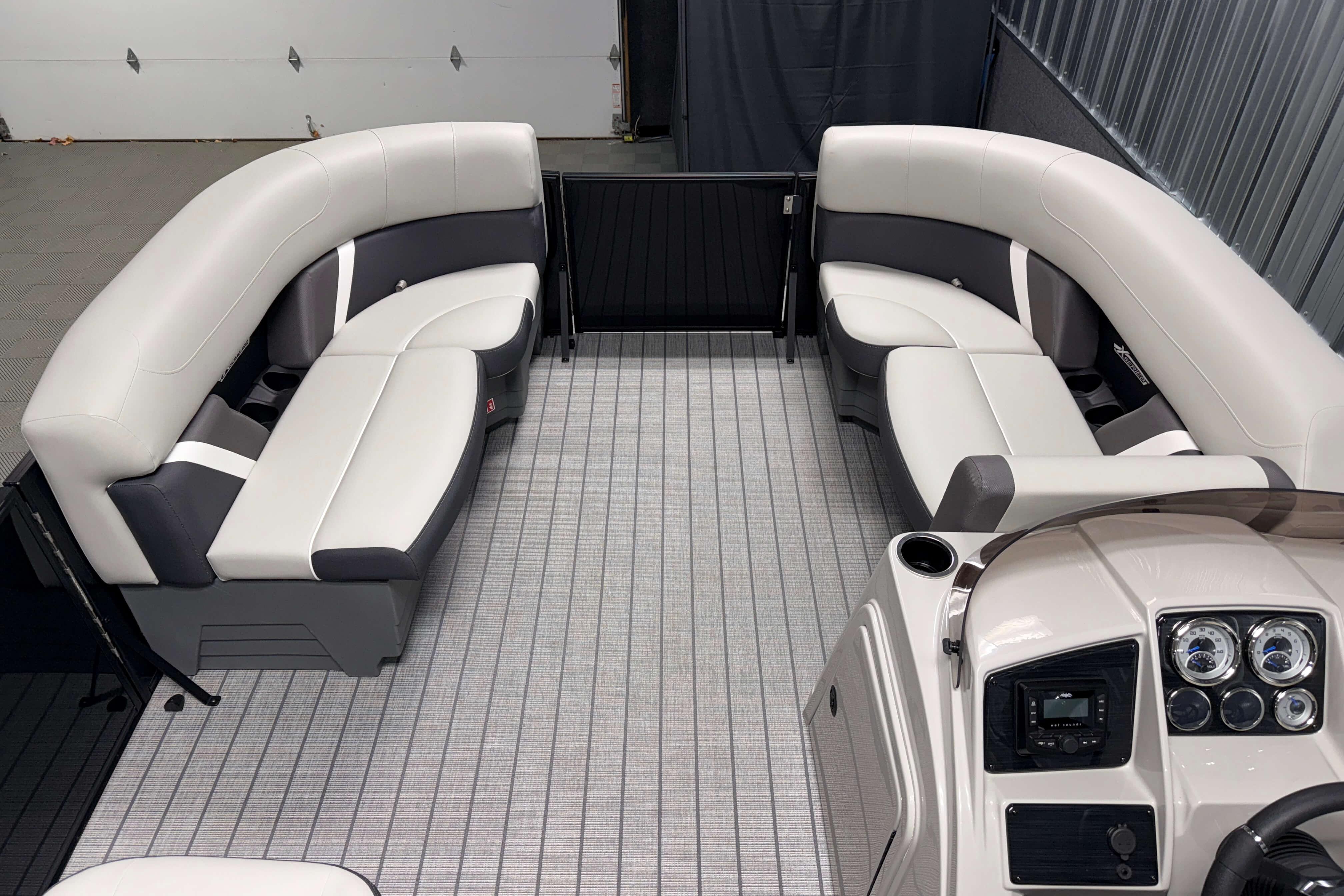 Luxurious interior of 2026 Sylvan Mirage X1 pontoon boat with plush seating and modern dashboard.