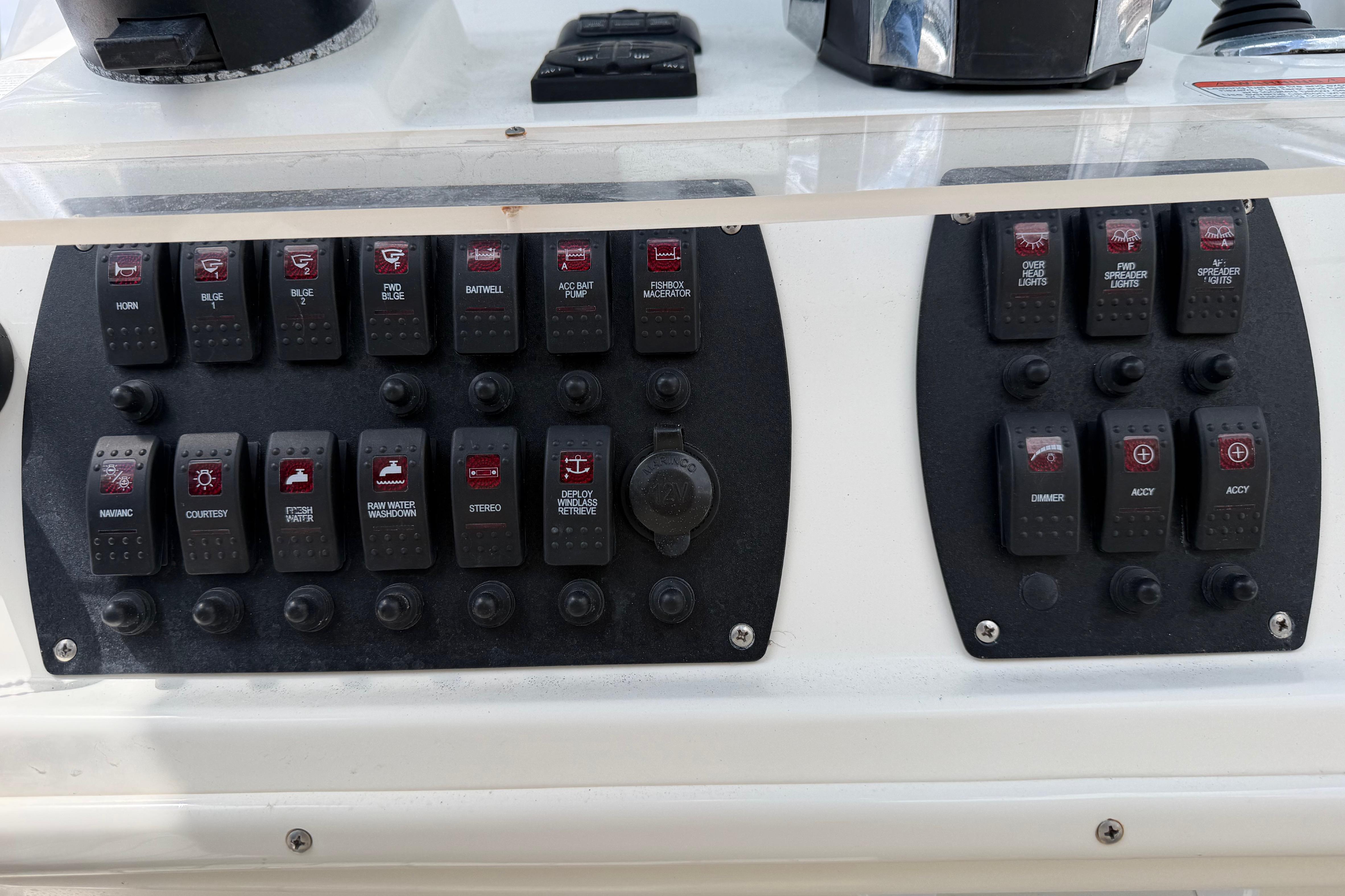 Control panel of a 2017 Mako 284 Center Console boat with various switches.