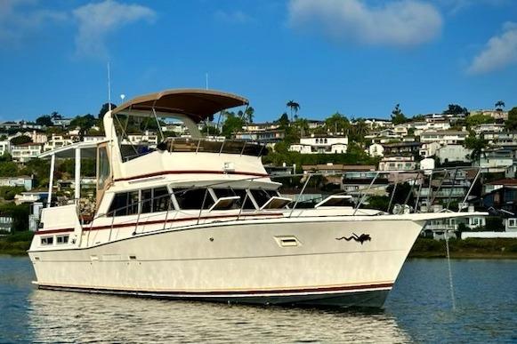 1980 Viking 43 Convertible yacht anchored in scenic coastal waters.