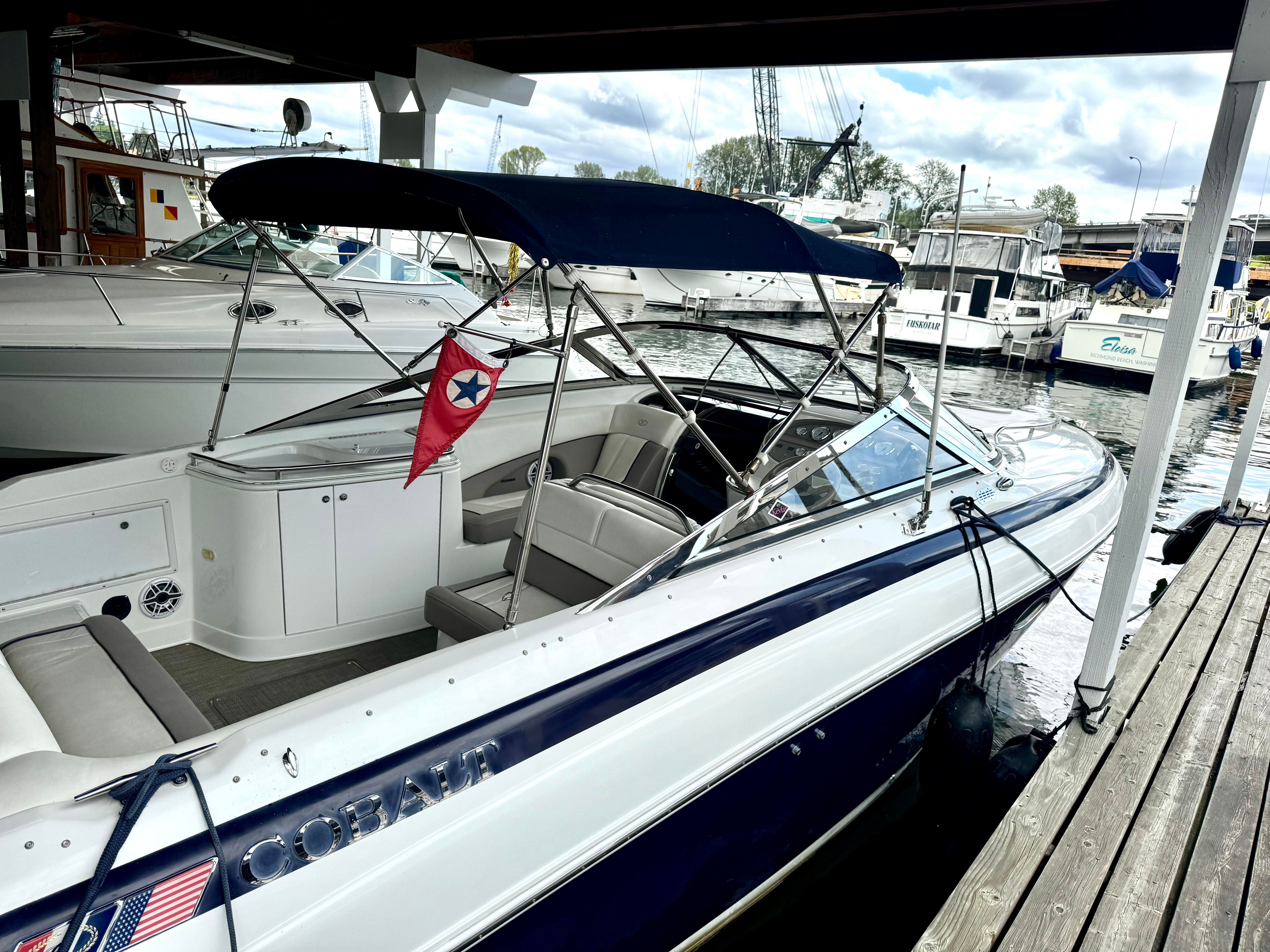 1999 Cobalt 293 boat docked with blue canopy.