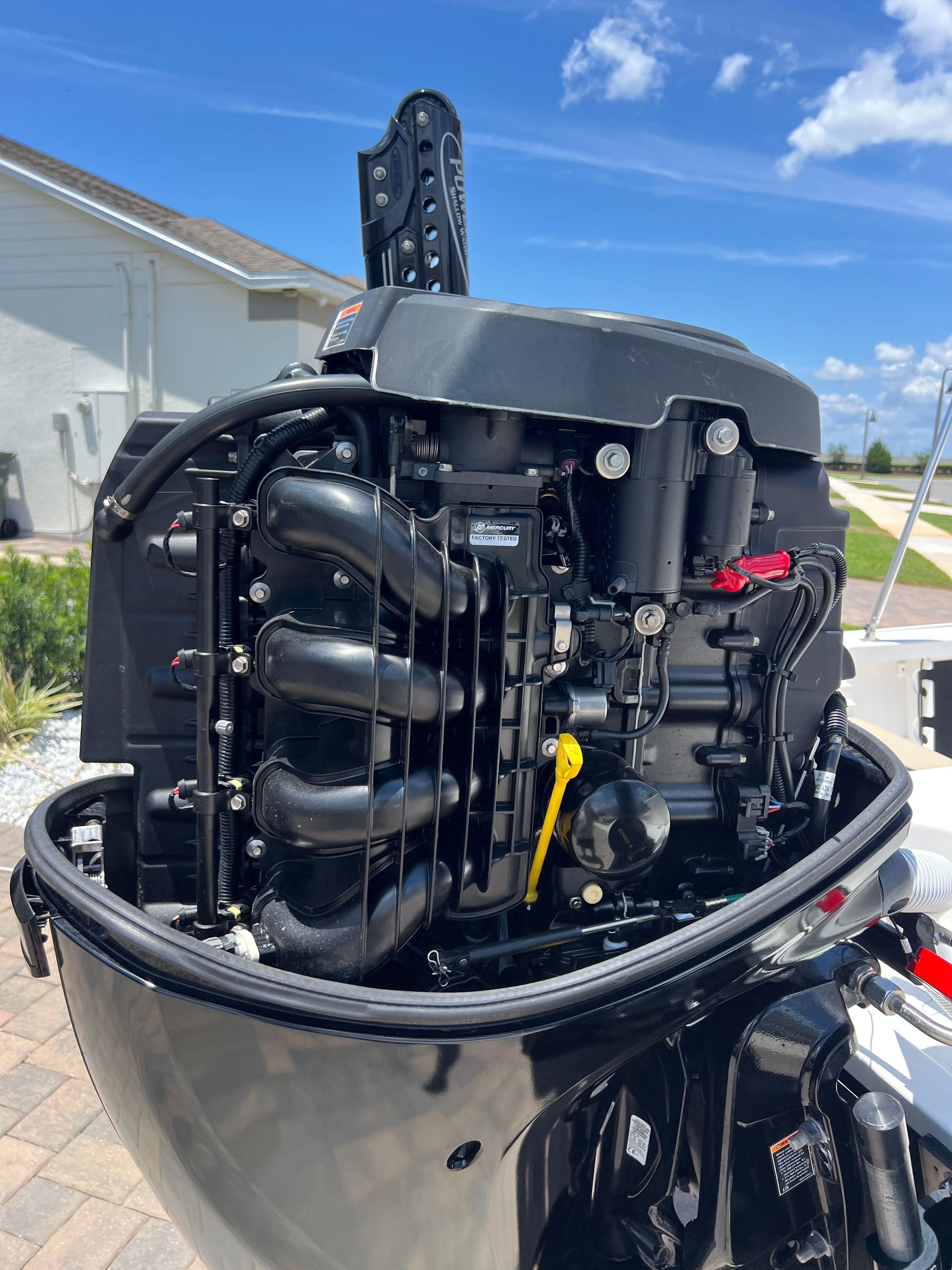 An outboard motor of a Tidewater 1910 Bay Max boat, captured on a sunny day.