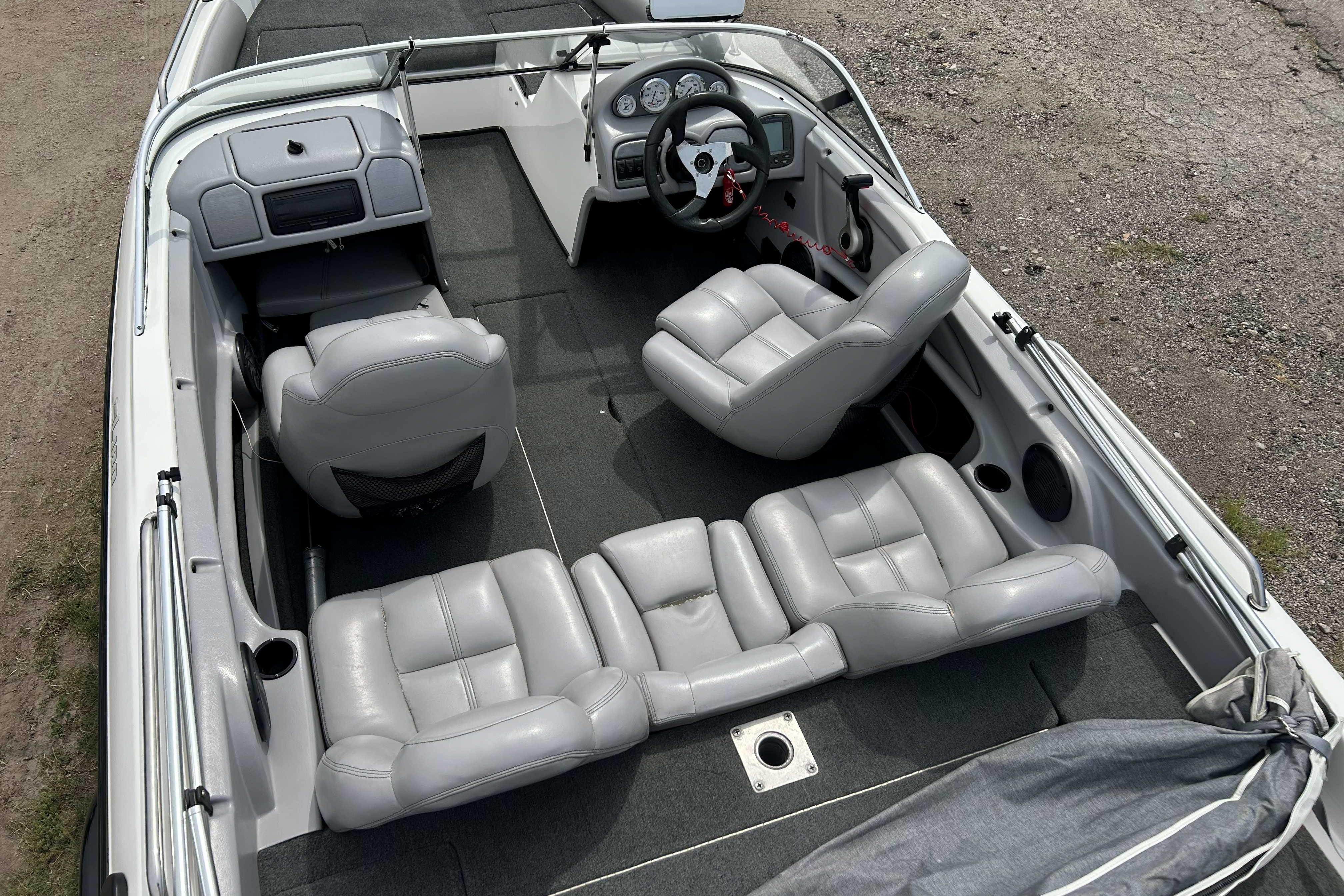 2010 Skeeter SL 180 boat interior with gray seating and steering console.