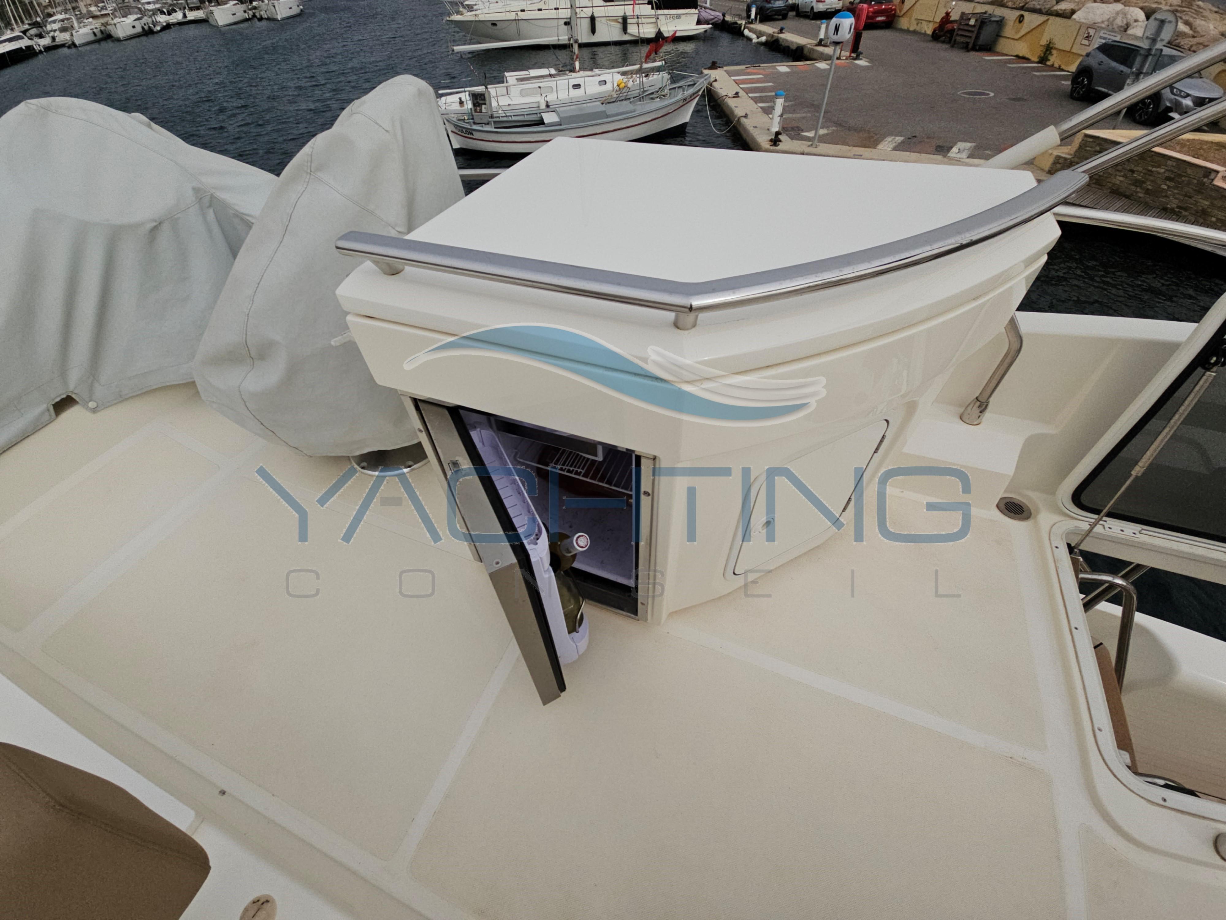 Flybridge of 2018 Absolute 45 FLY yacht with open storage compartment.
