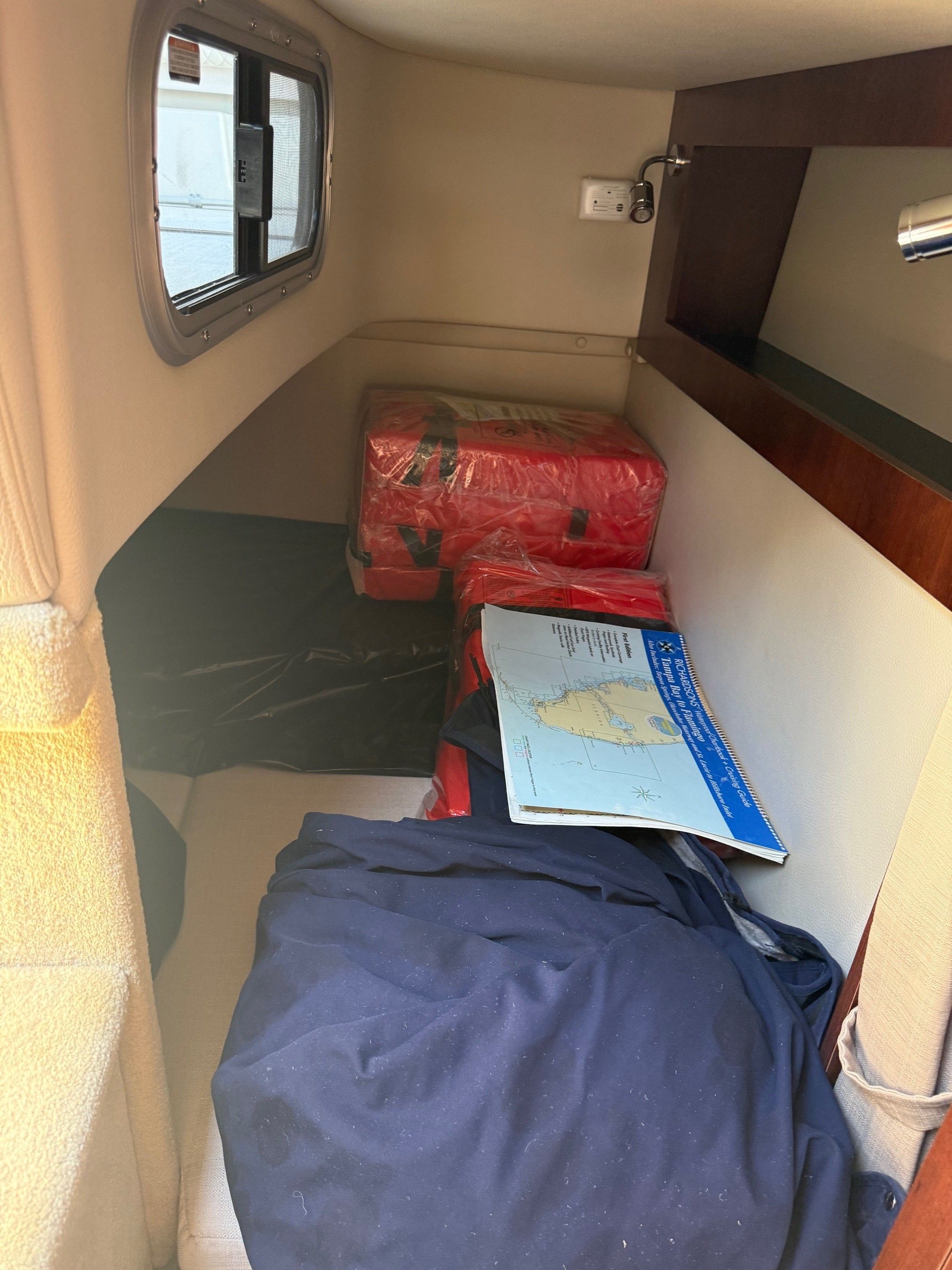 Interior of a 2018 Chaparral 270 Signature boat with maps and life jackets.