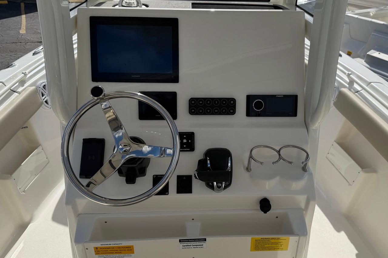 Helm of 2026 Key West 239 FSR boat with steering wheel and control panel.