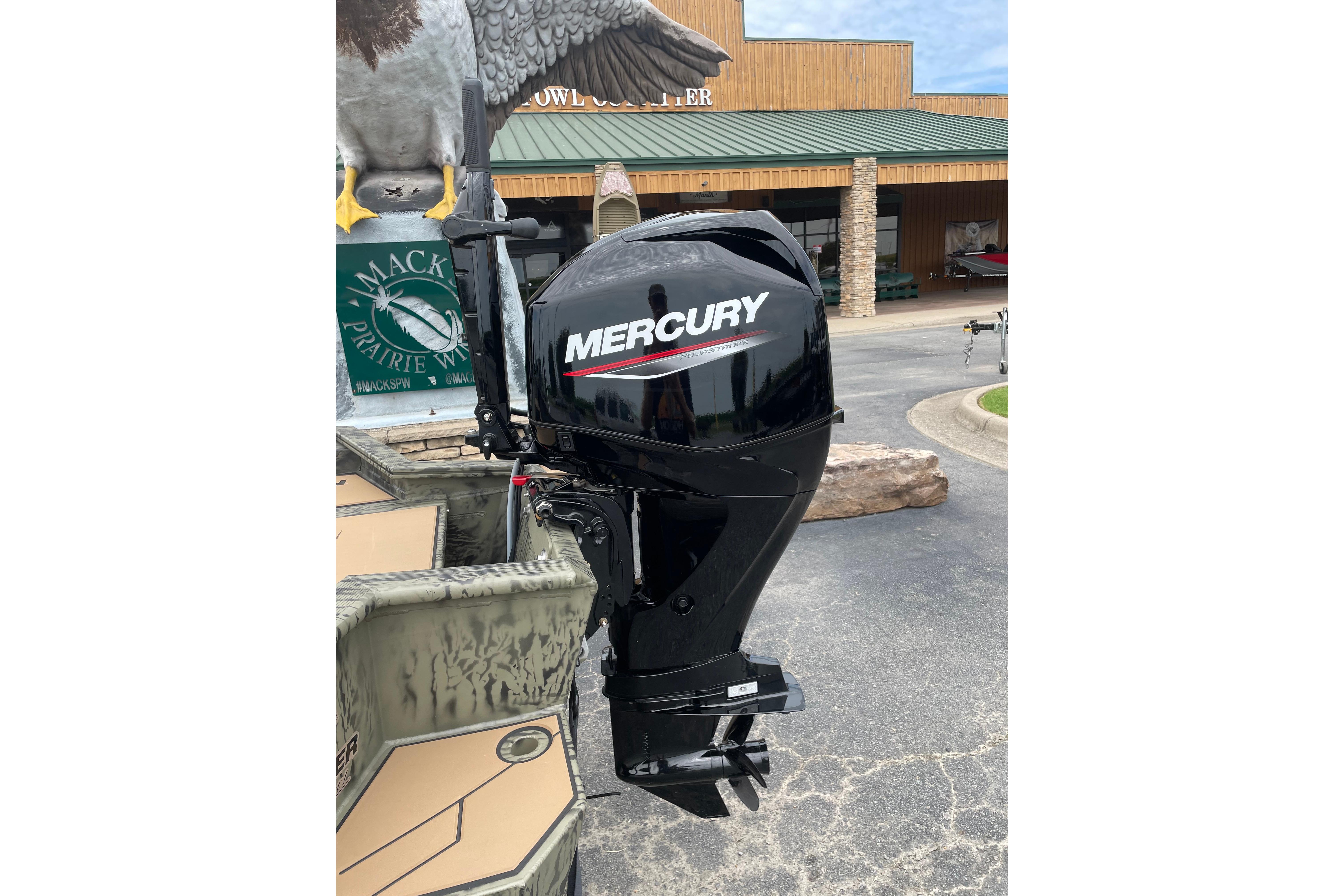 2026 Tracker Grizzly 1756 T Marsh boat with Mercury outboard motor displayed outdoors.