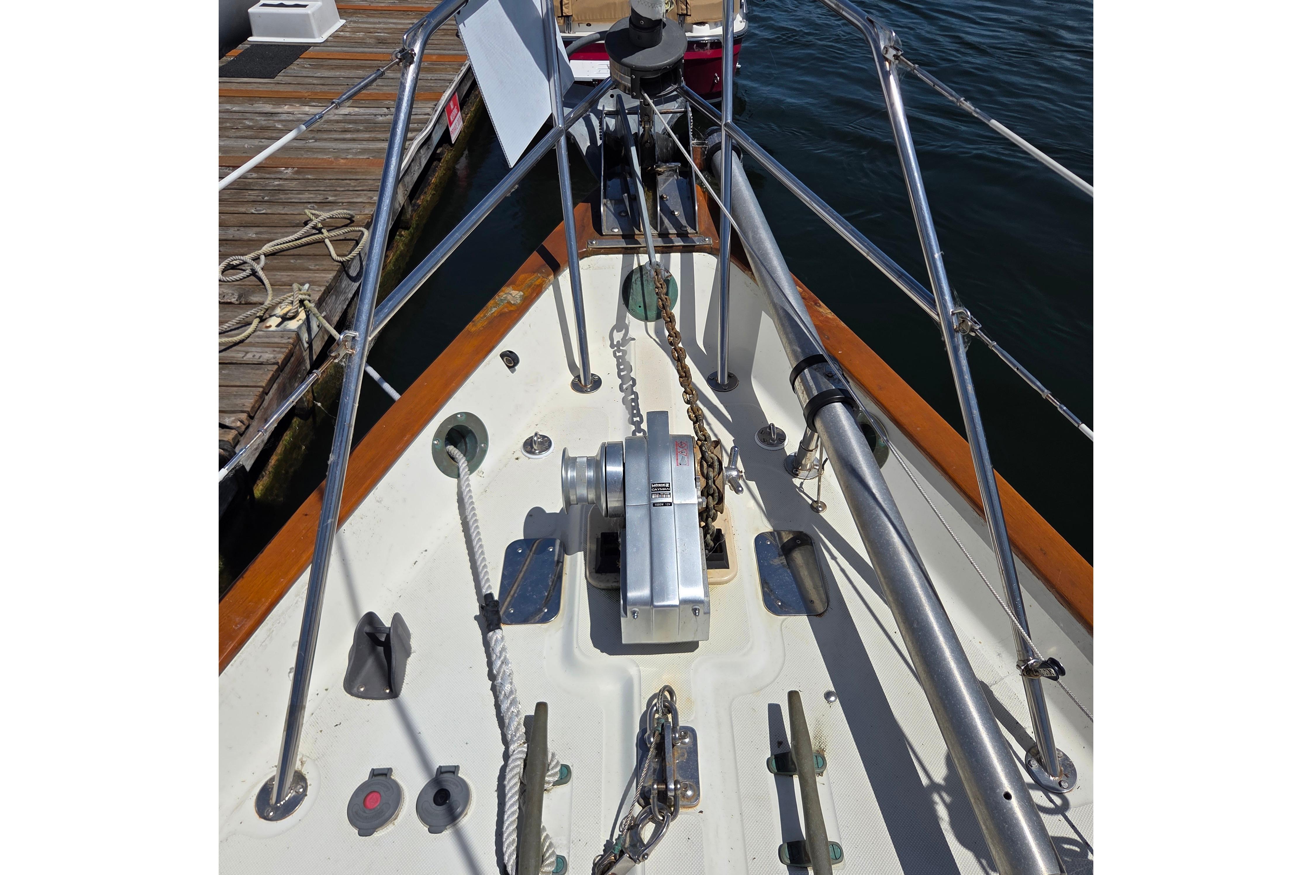 Bow of 1983 Pacific Seacraft 34 sailboat with anchor chain and winch.