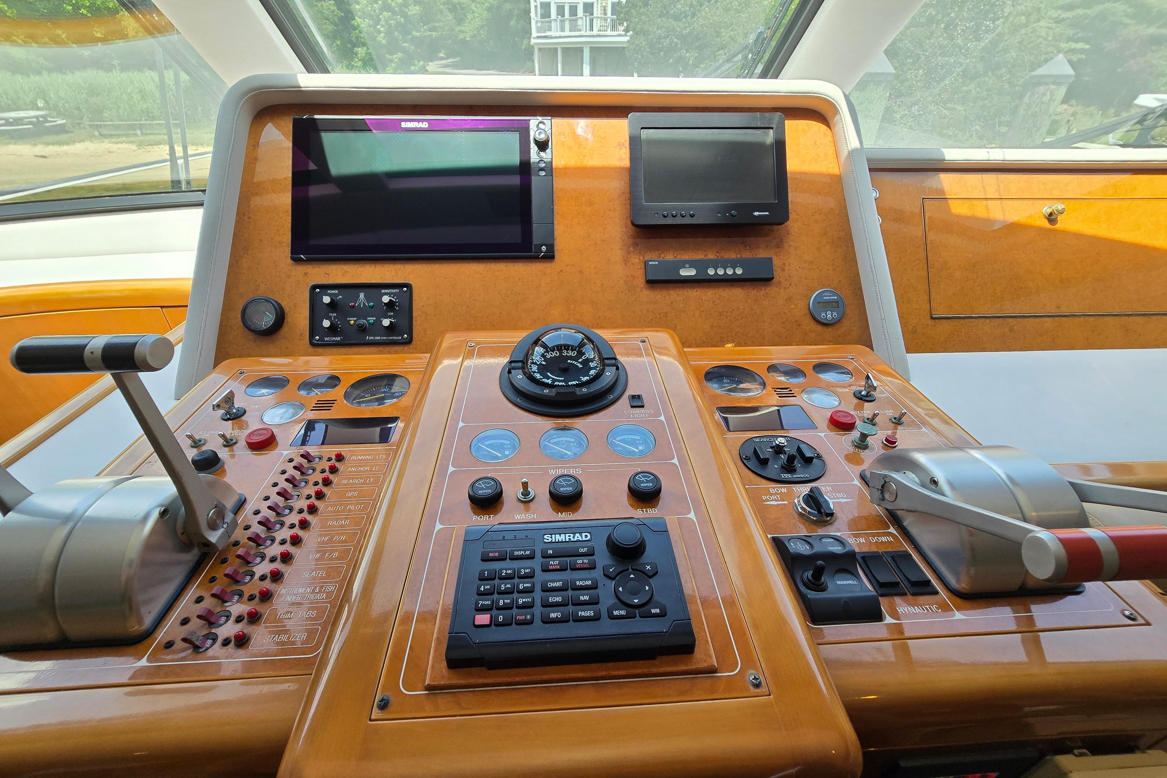 Control panel of a 2004 Grand Harbour 58 yacht with navigation instruments and controls.