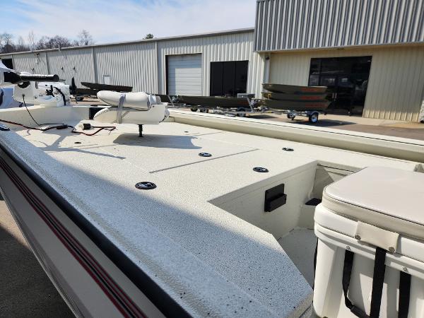 2025 Ranger RB200 boat with spacious deck, parked outside a metal building.