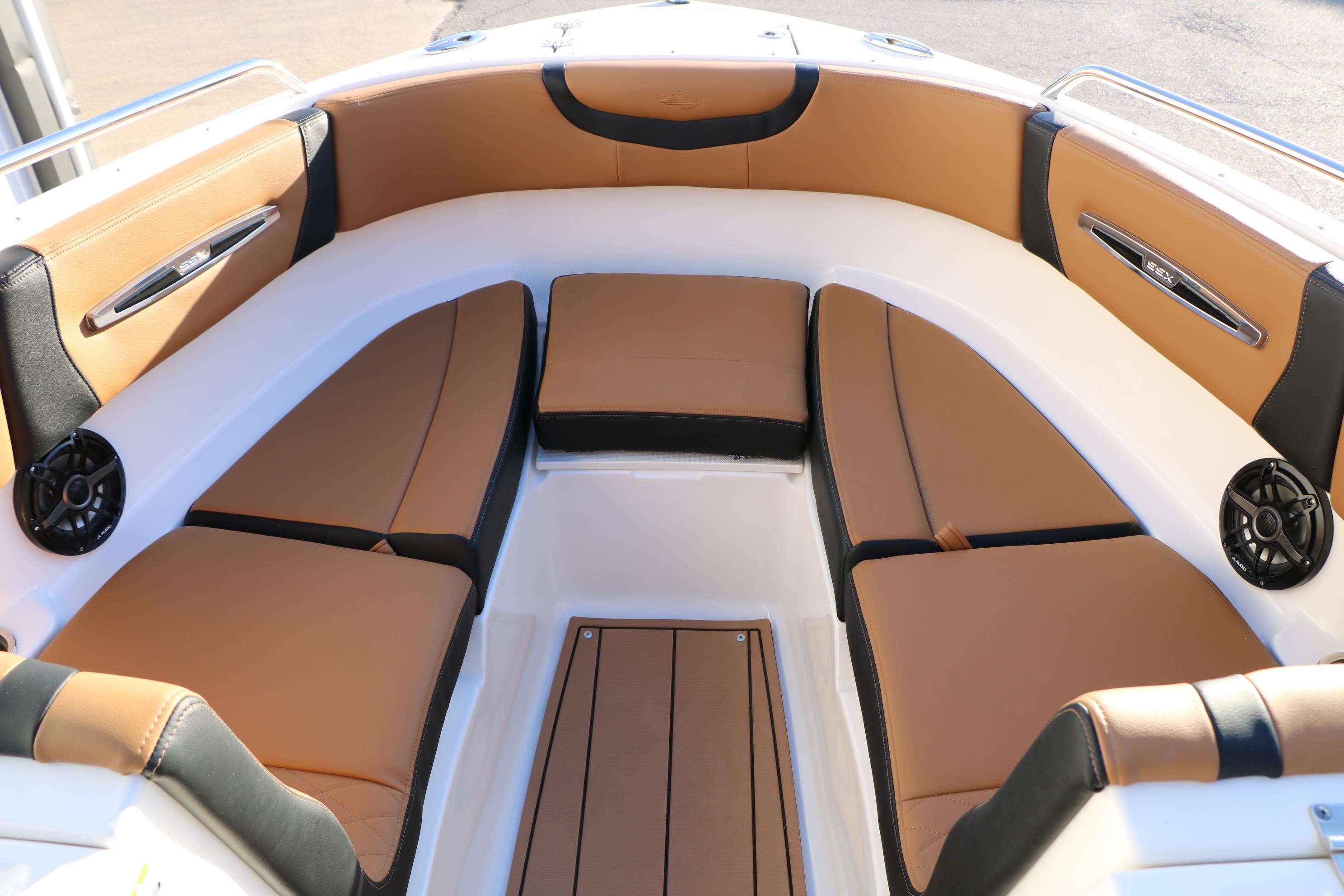 Luxurious seating area on 2026 Chaparral 247 SSX boat, featuring tan and black upholstery.