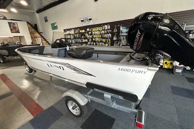 2027 Lund 1600 Fury SS boat with Mercury engine in showroom display.