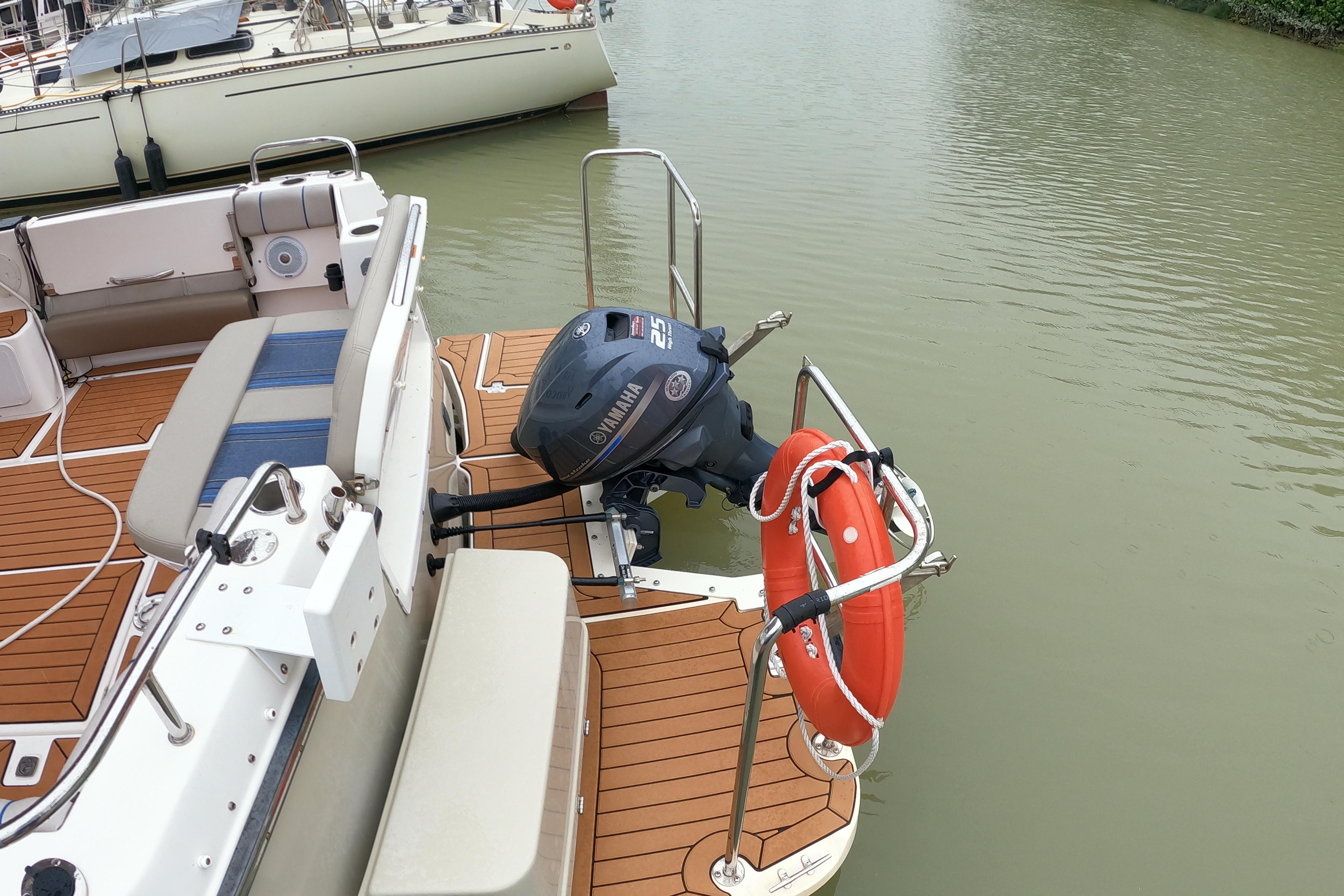 2019 Cutwater C-30 Sedan boat with Yamaha outboard motor and lifebuoy on deck.