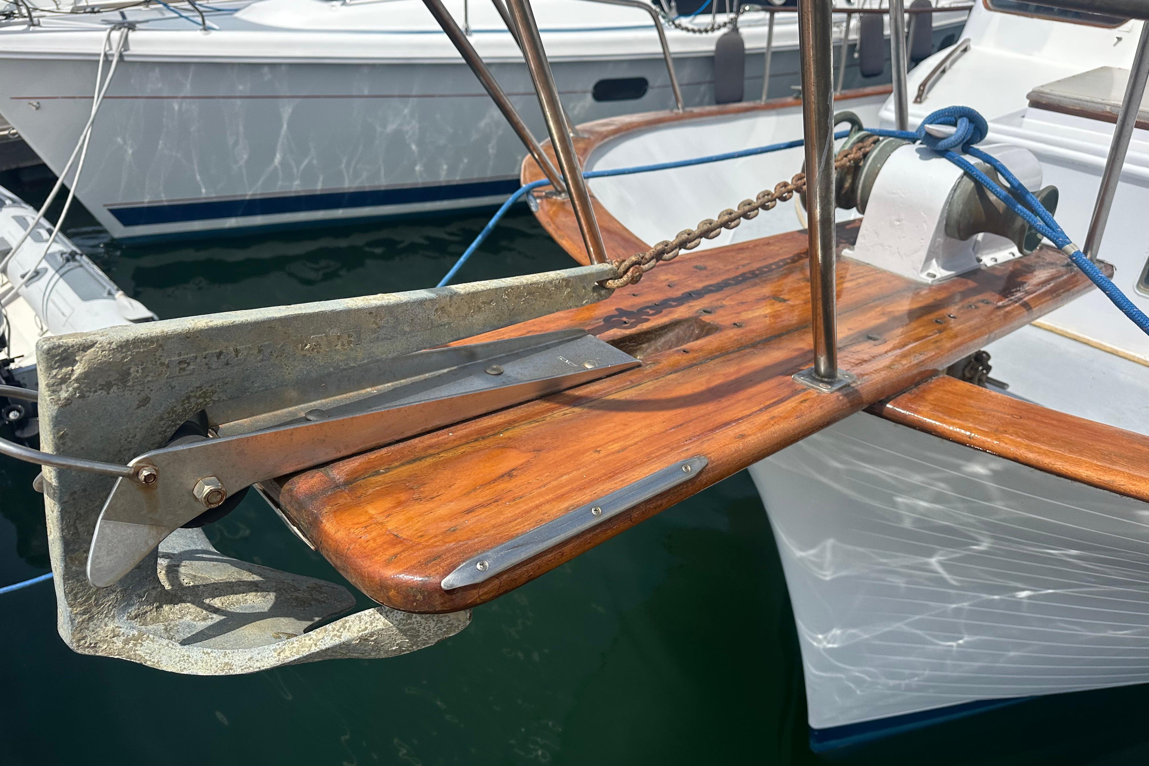 Bow of a 1973 CHB 33 boat with anchor and wooden deck detail.