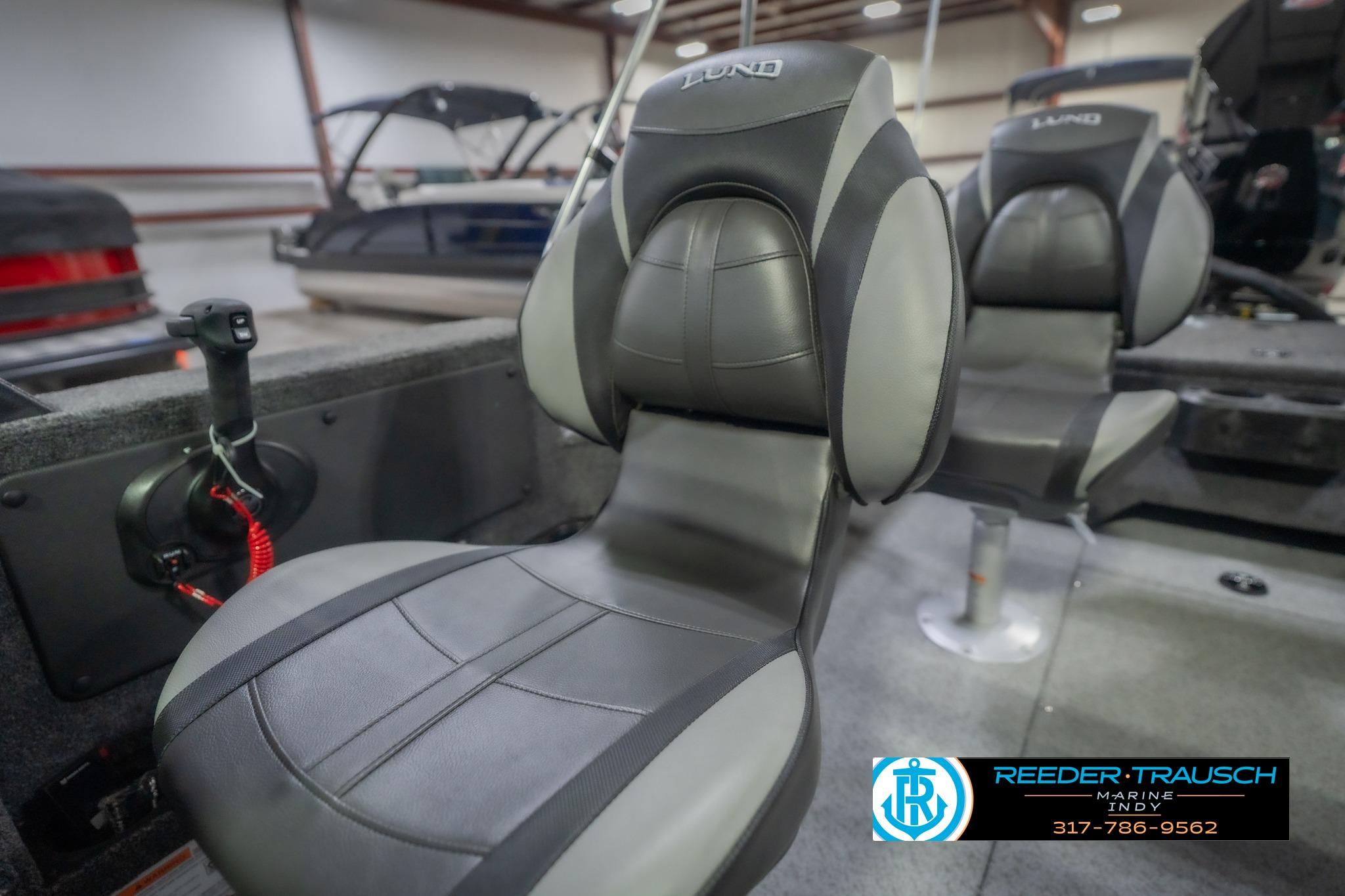 2026 Lund 2075 Impact XS boat seats in showroom, featuring sleek design and comfort.