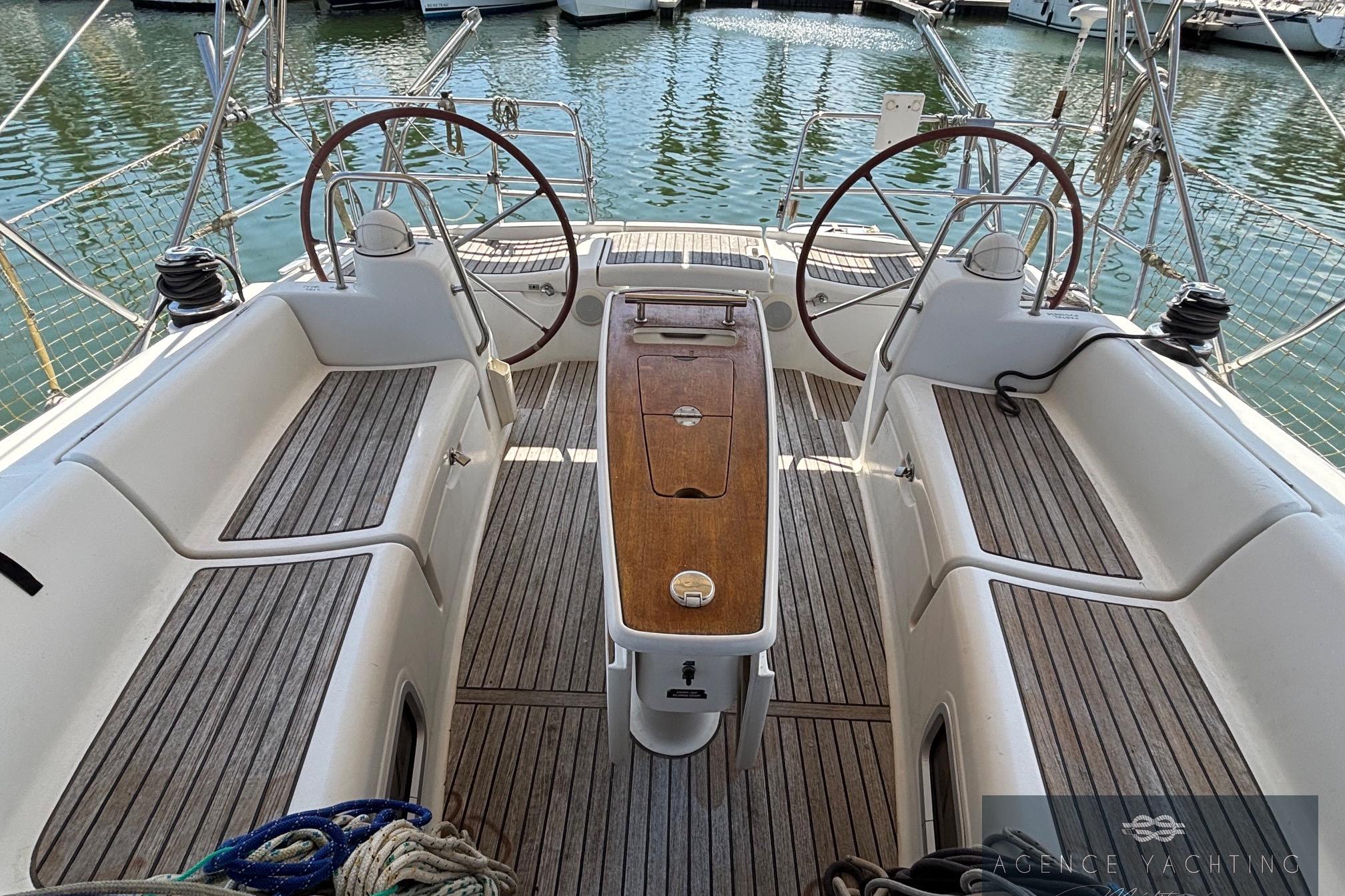 Cockpit of 2008 Beneteau Oceanis 40 sailboat with dual steering wheels and teak flooring.