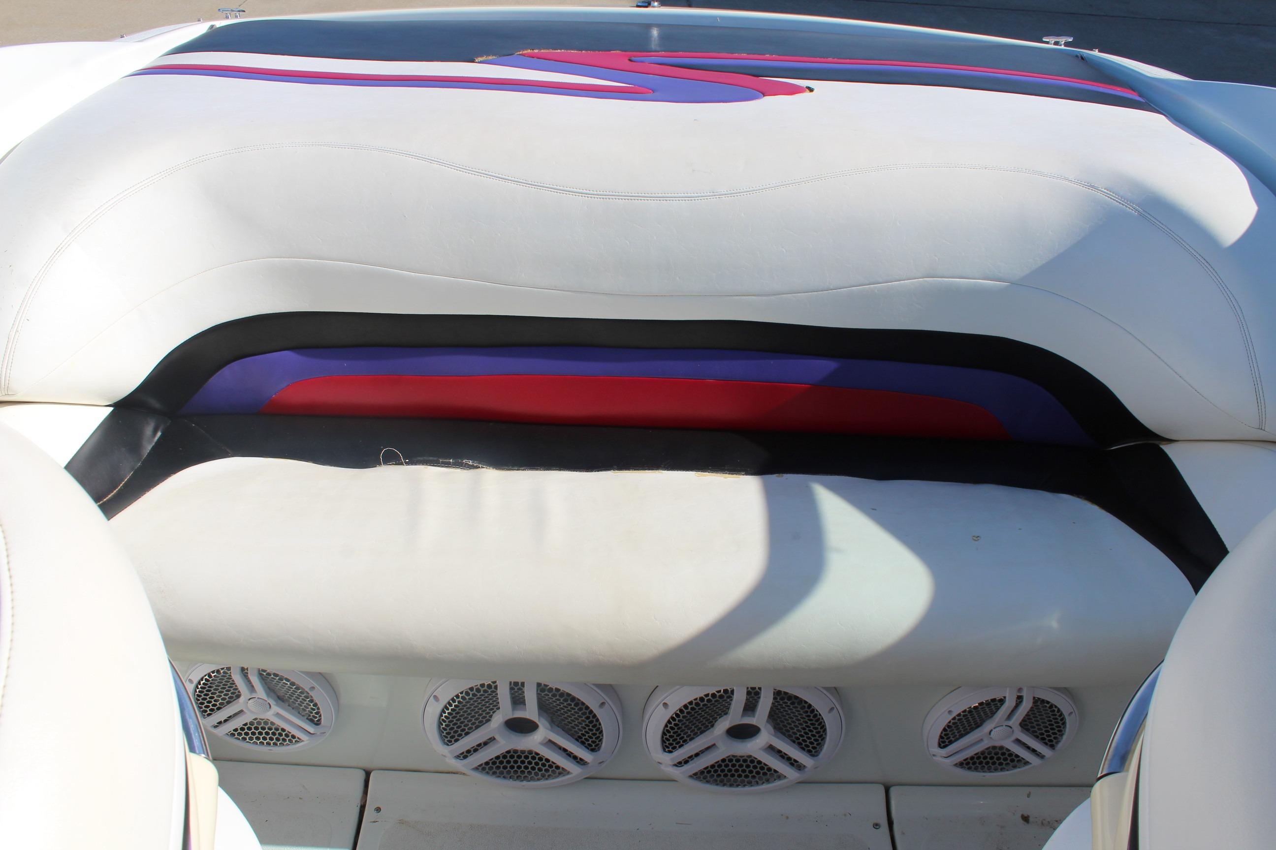 1996 Baja 232 boat interior with colorful upholstery and built-in speakers.